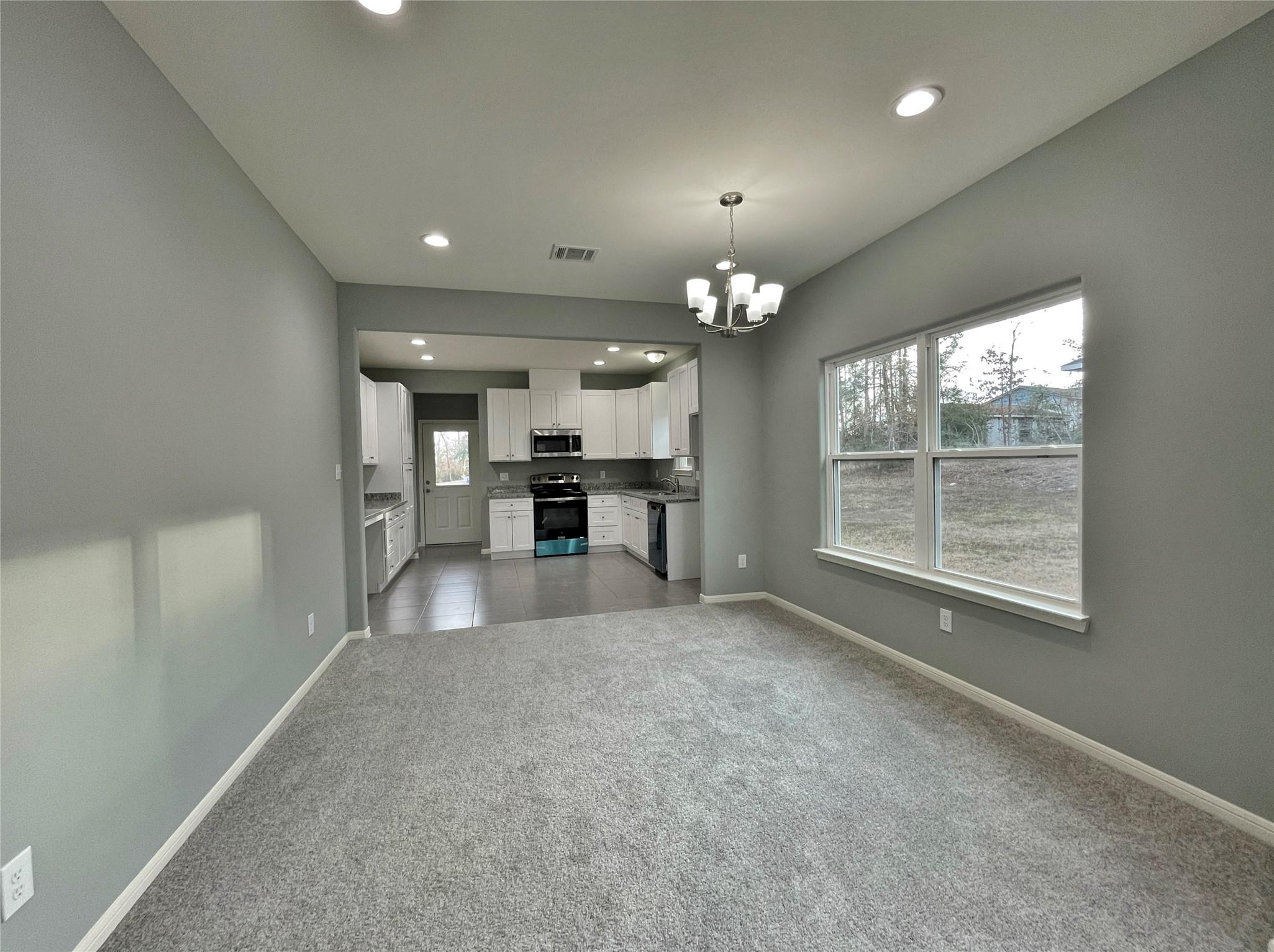 Image 3: The dining room area has 9' ceilings and a large w