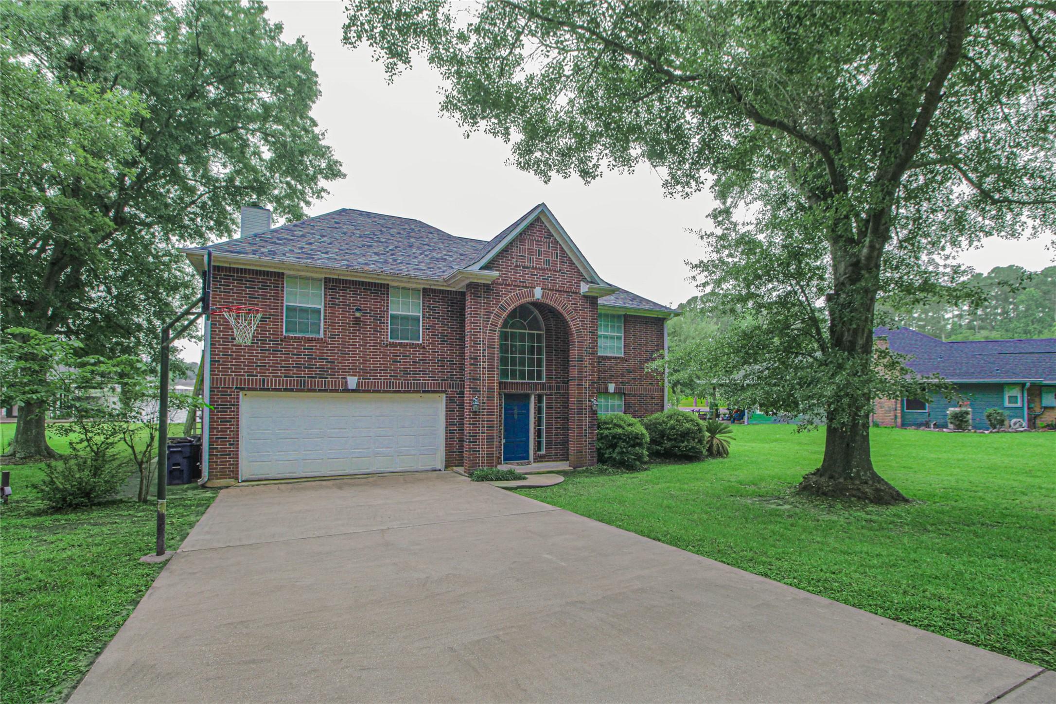 Image 2: This is a two-story brick home with a welcoming ar
