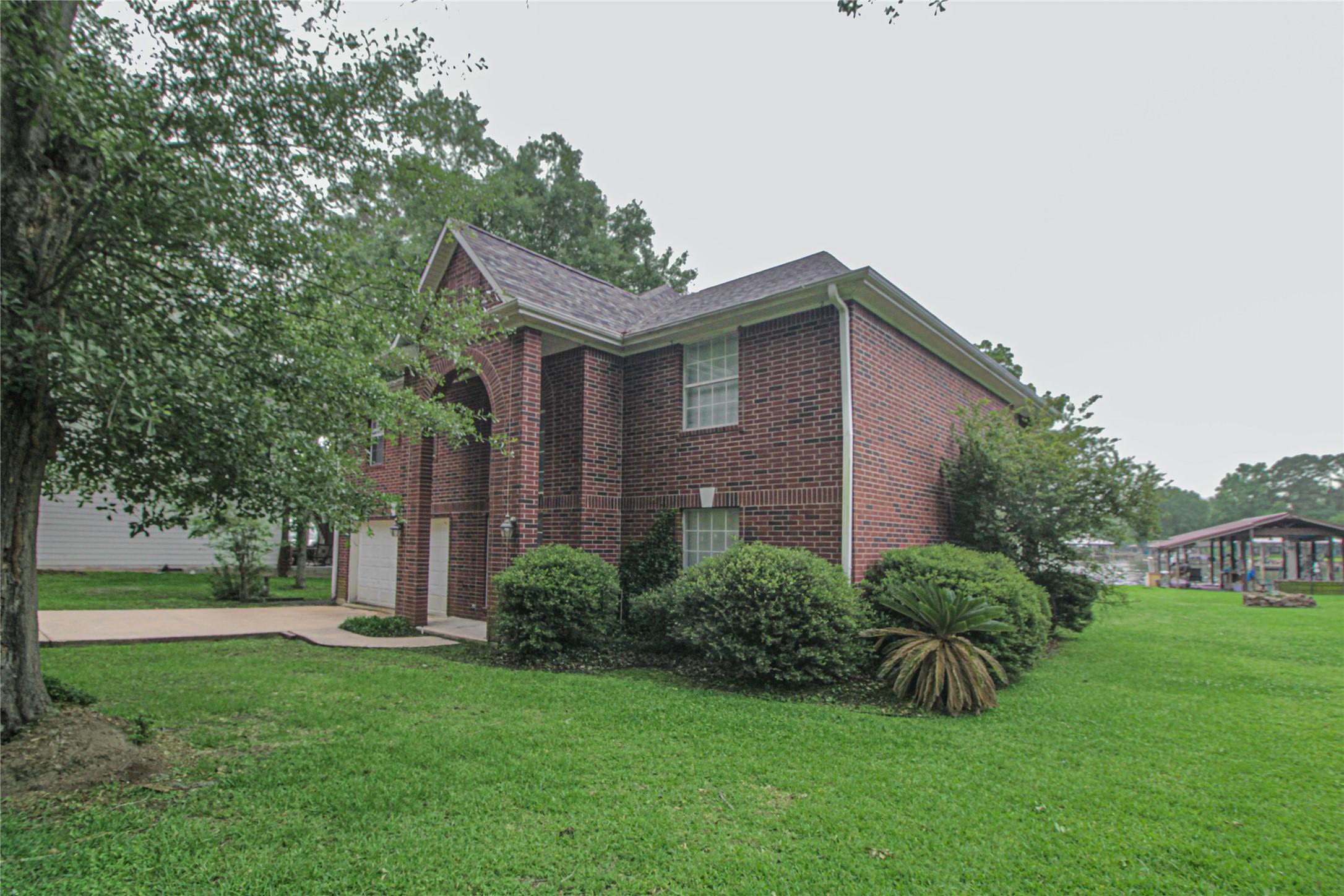 Image 3: This two-story brick home features a classic desig