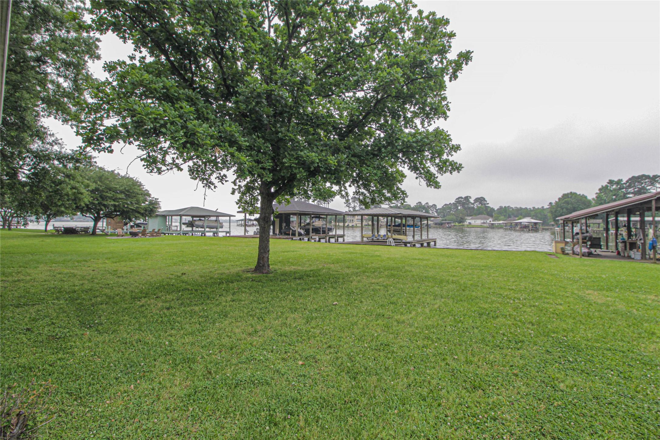 Image 4: Lakeside property with a spacious, green lawn and