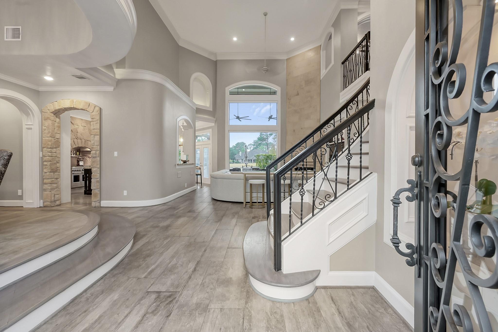 Image 4: Spacious foyer with soaring ceilings, curved archi