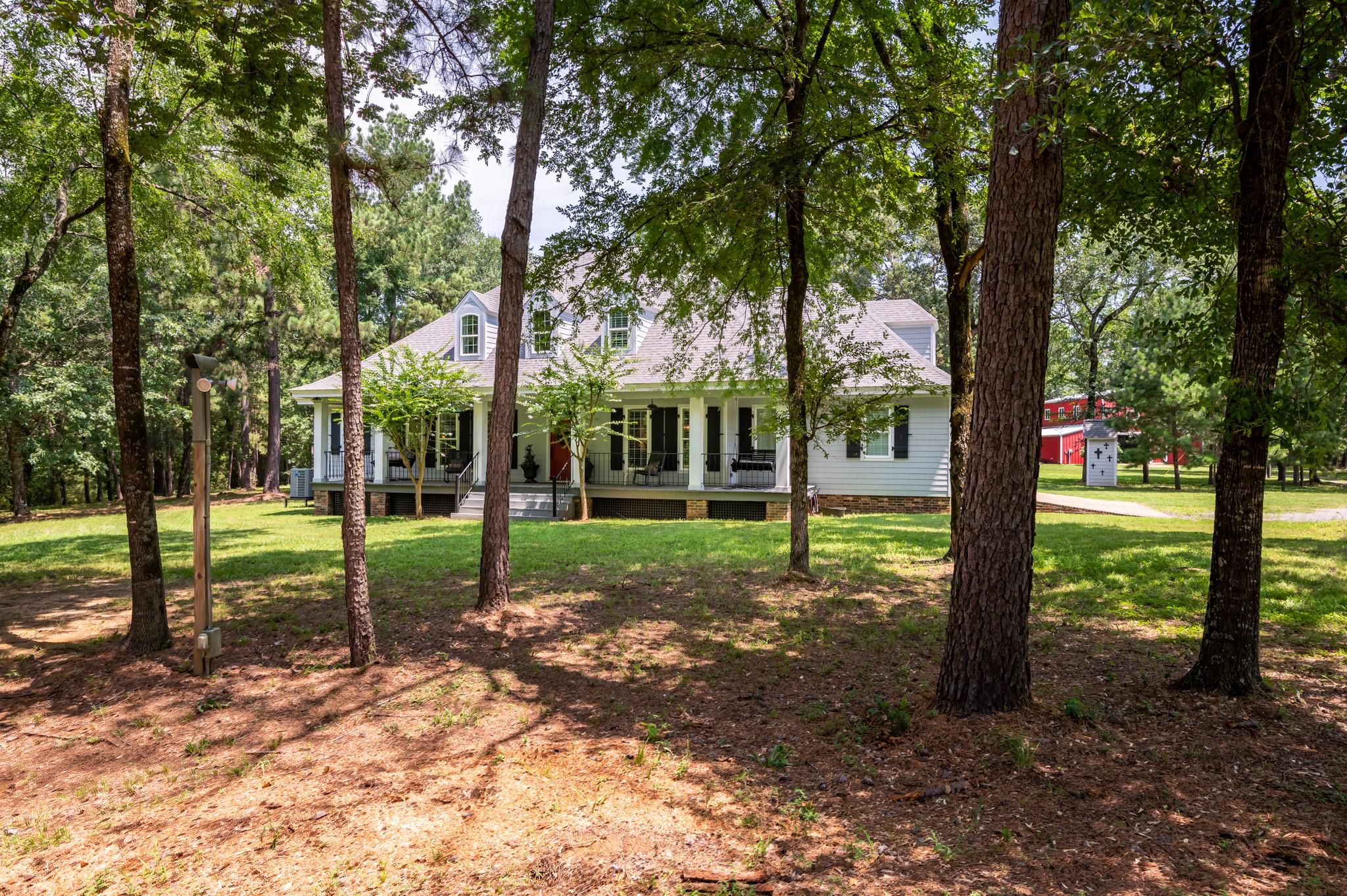 Image 3: Trees in front of the home provide shade and priva