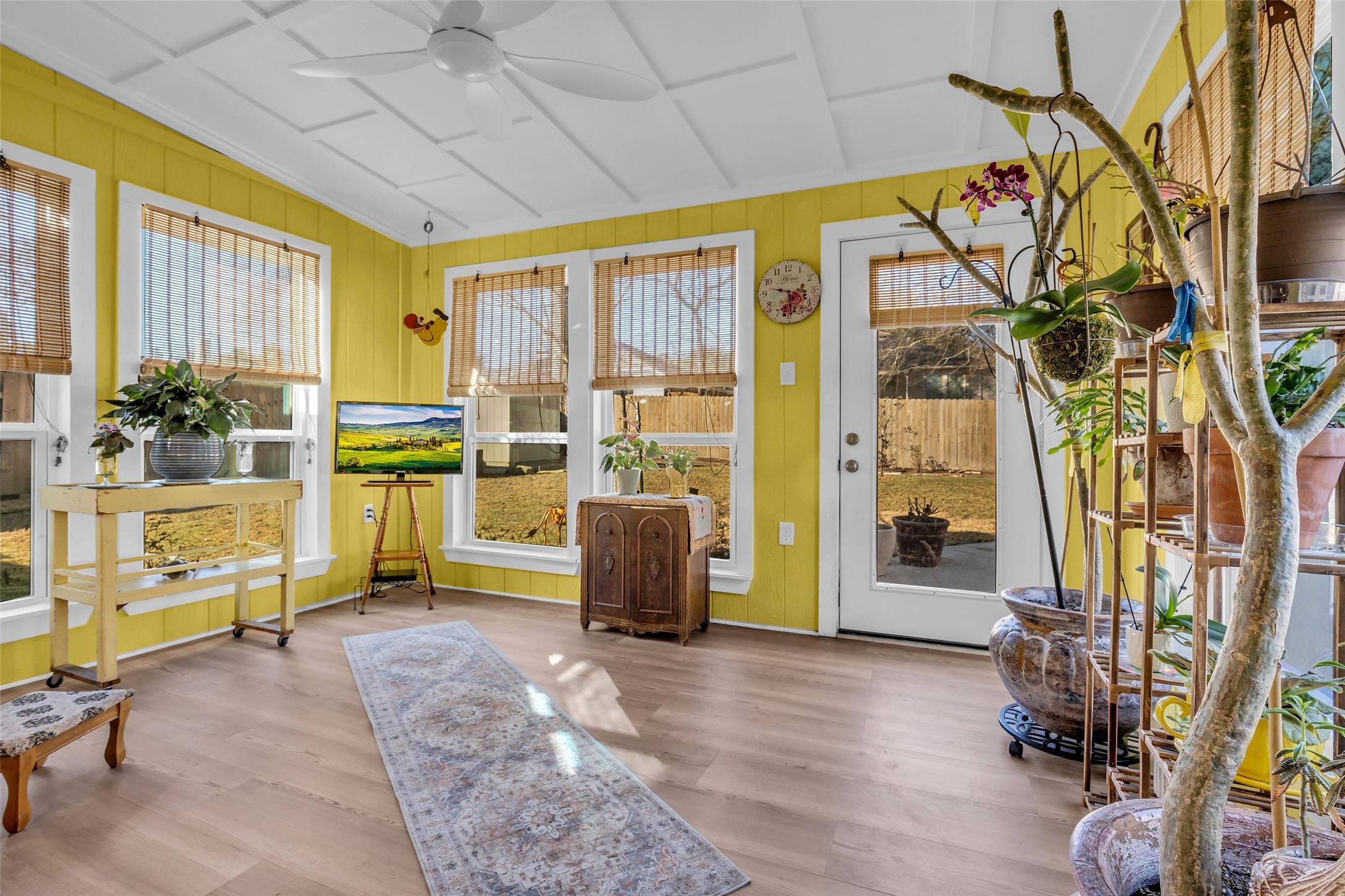 Image 3: Cheerful sunroom recently added, expands indoor/ou