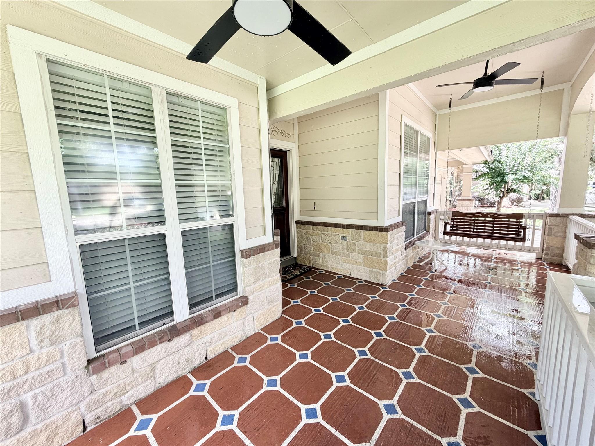 Image 3: This inviting covered porch offers a charming outd