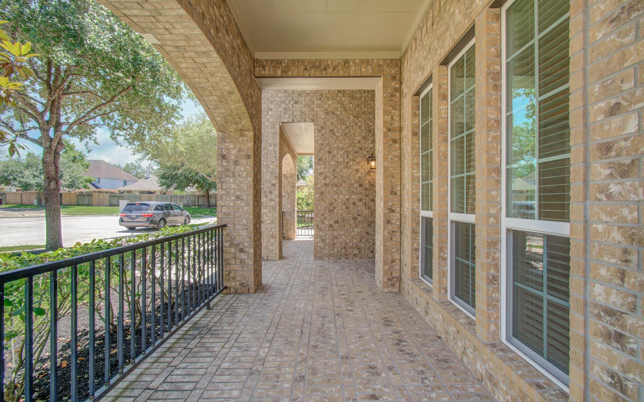 Image 3: Covered front porch with arched brickwork, large w