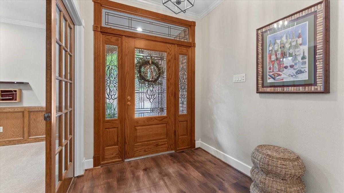 Image 3: A welcoming entryway features a beautiful wooden f