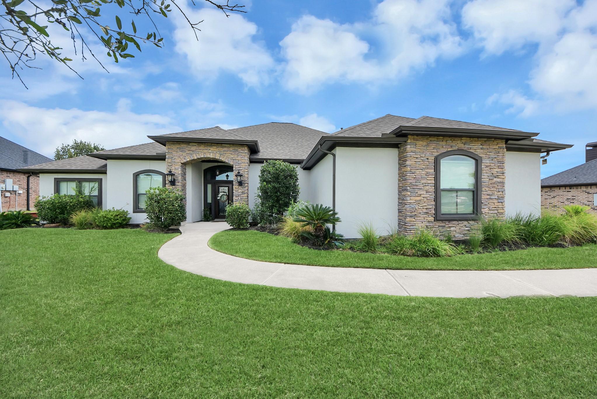 Image 2: Stunning single-story home with a charming stone f