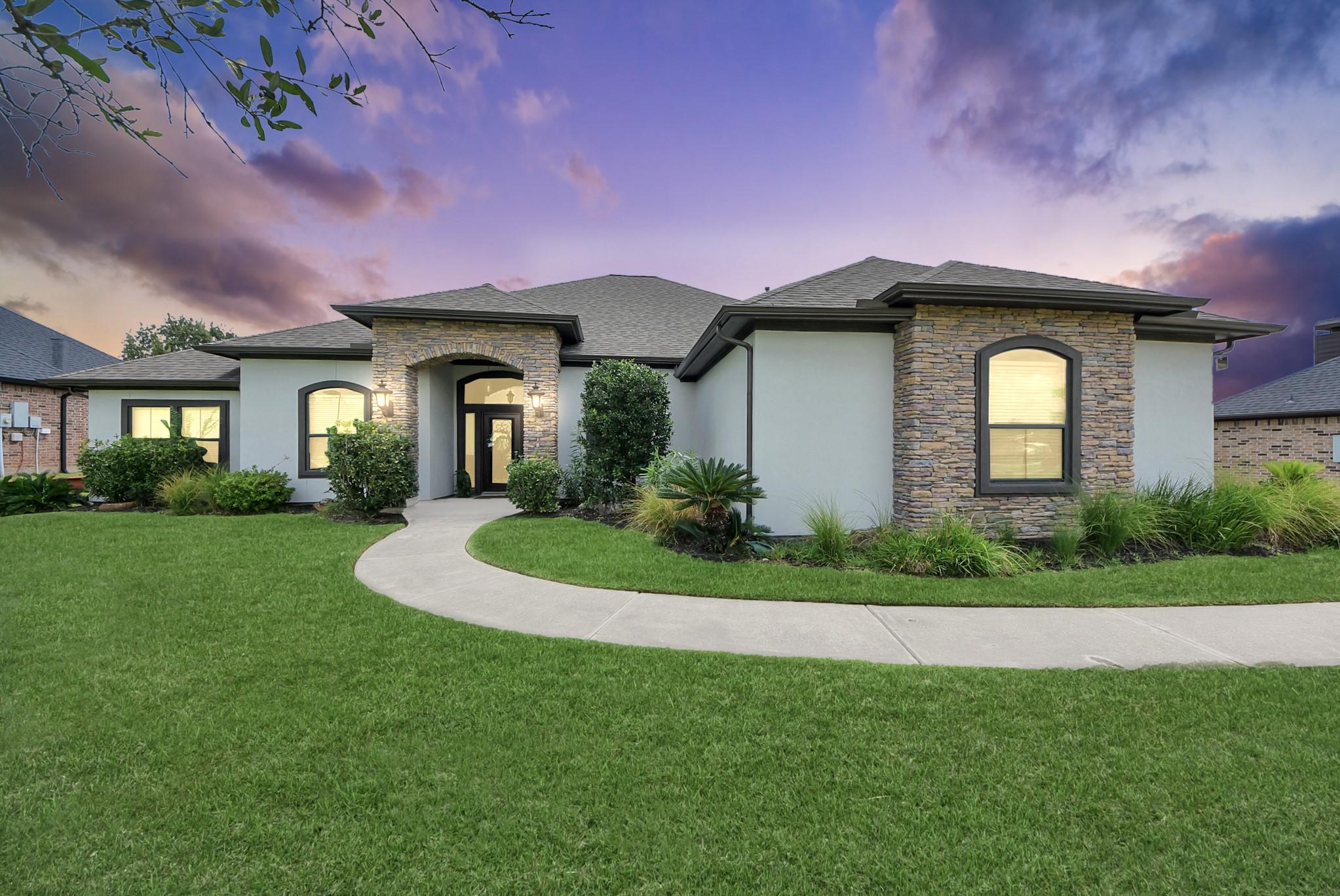 Image 3: Stunning single-story home with elegant stone acce