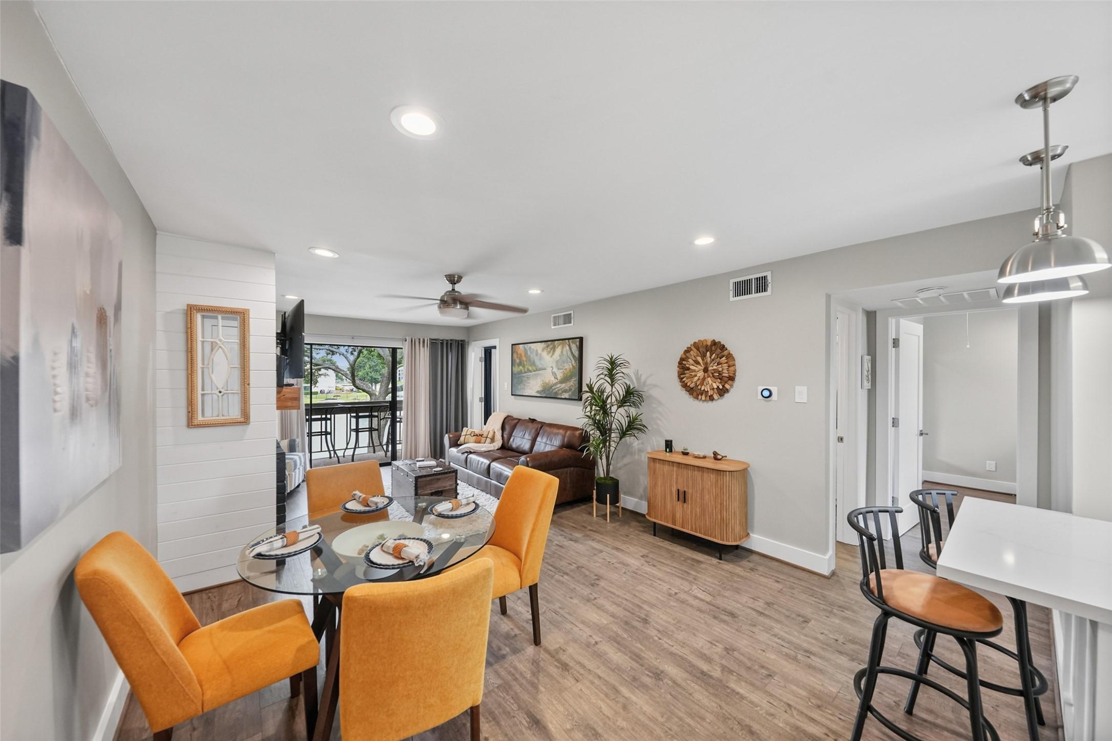 Image 2: This modern dining area features a round glass tab