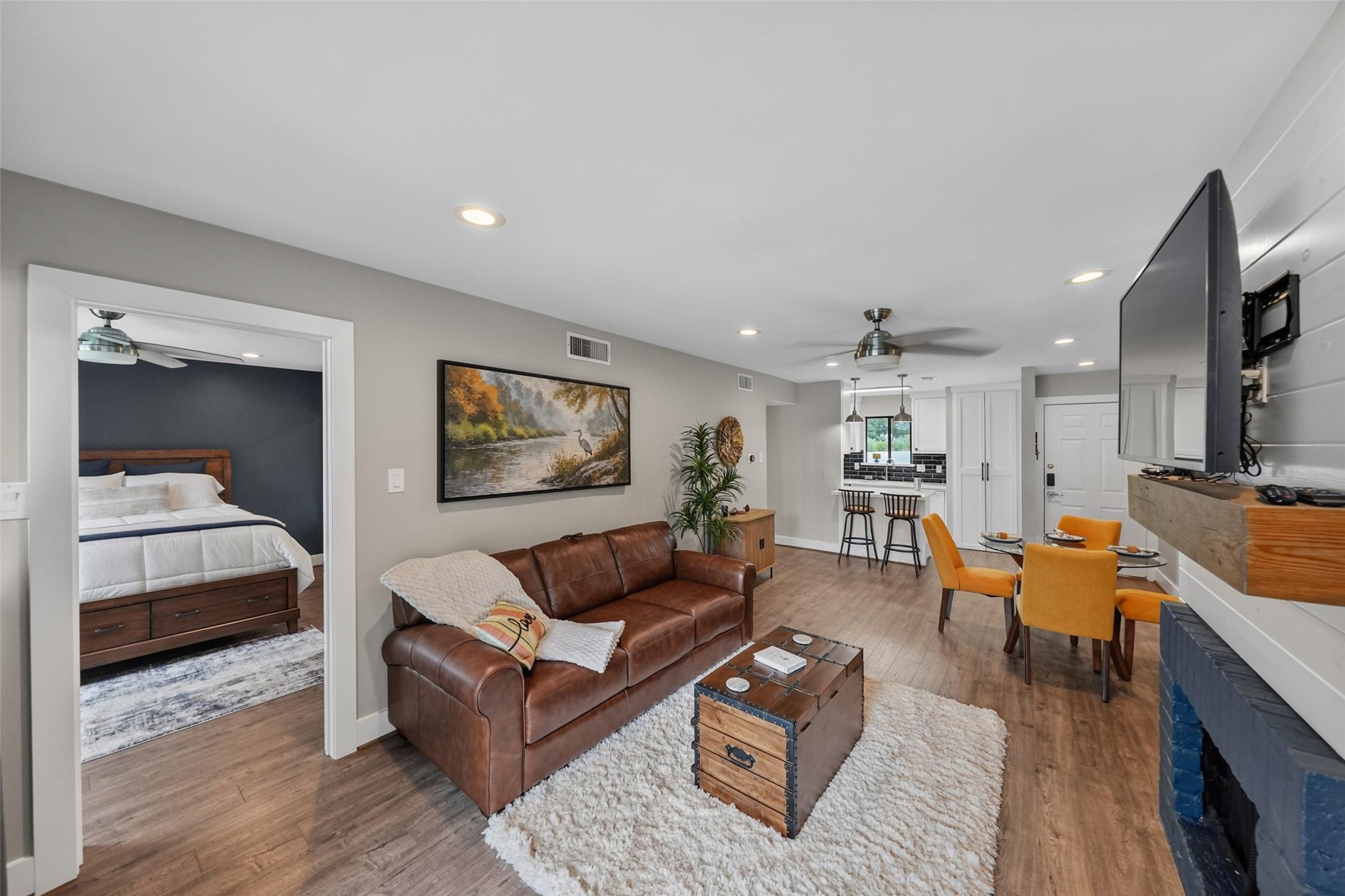 Image 4: This cozy open-plan living space features a leathe