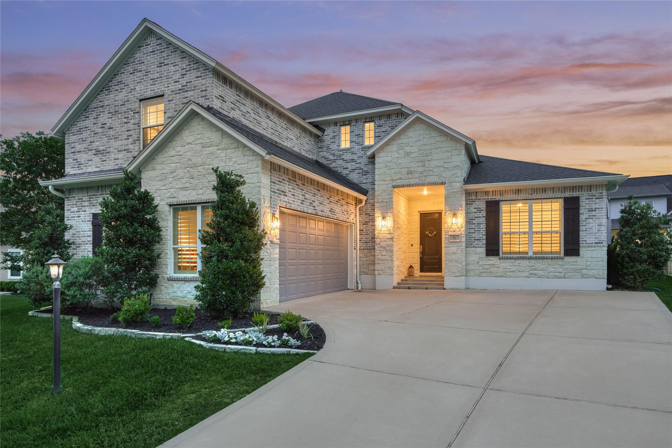 Image 4: Double-wide driveway with a 2-car garage