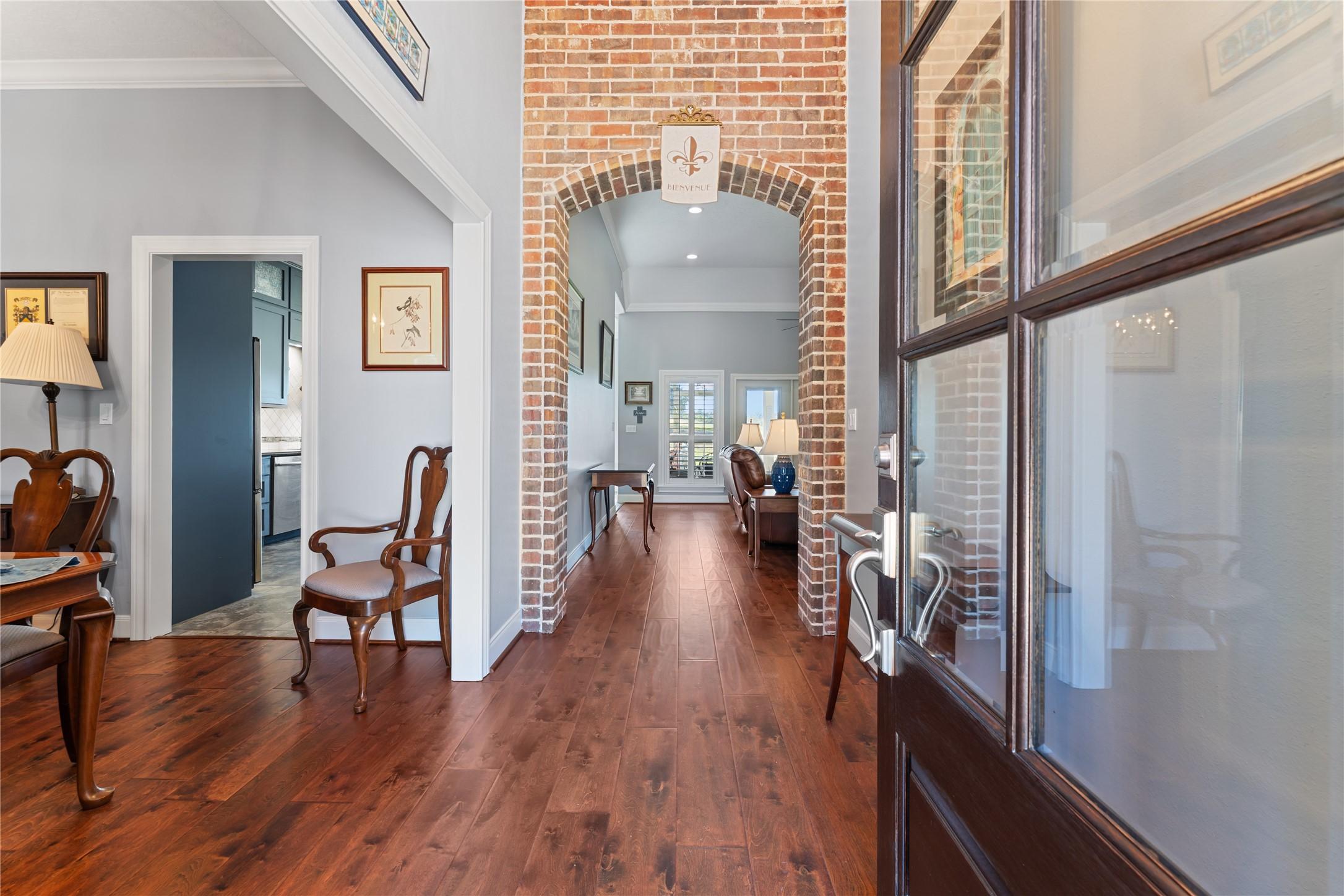 Image 4: As you enter the foyer you are greeted by a brick