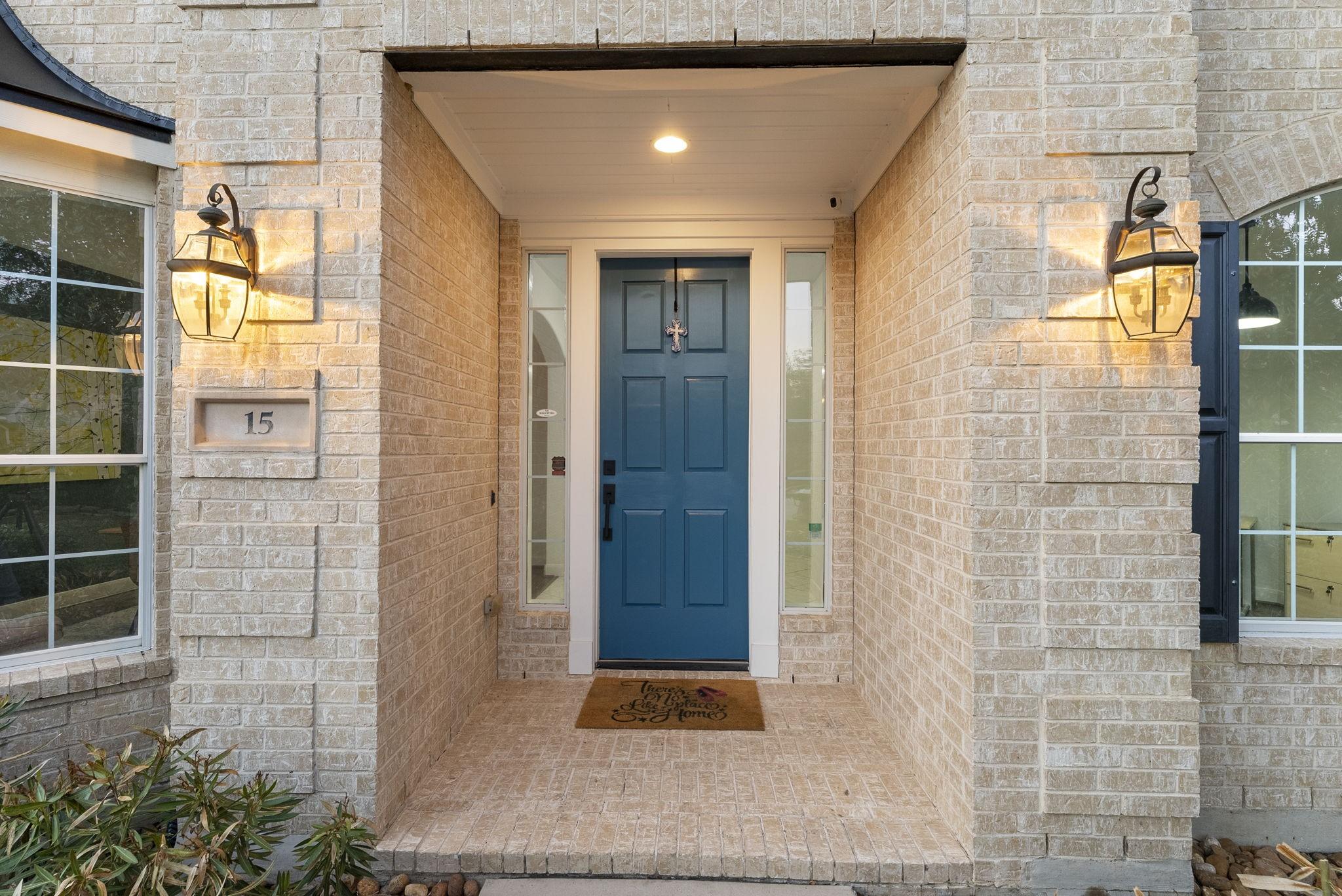 Image 3: Coach lighting and a charming blue front door acce