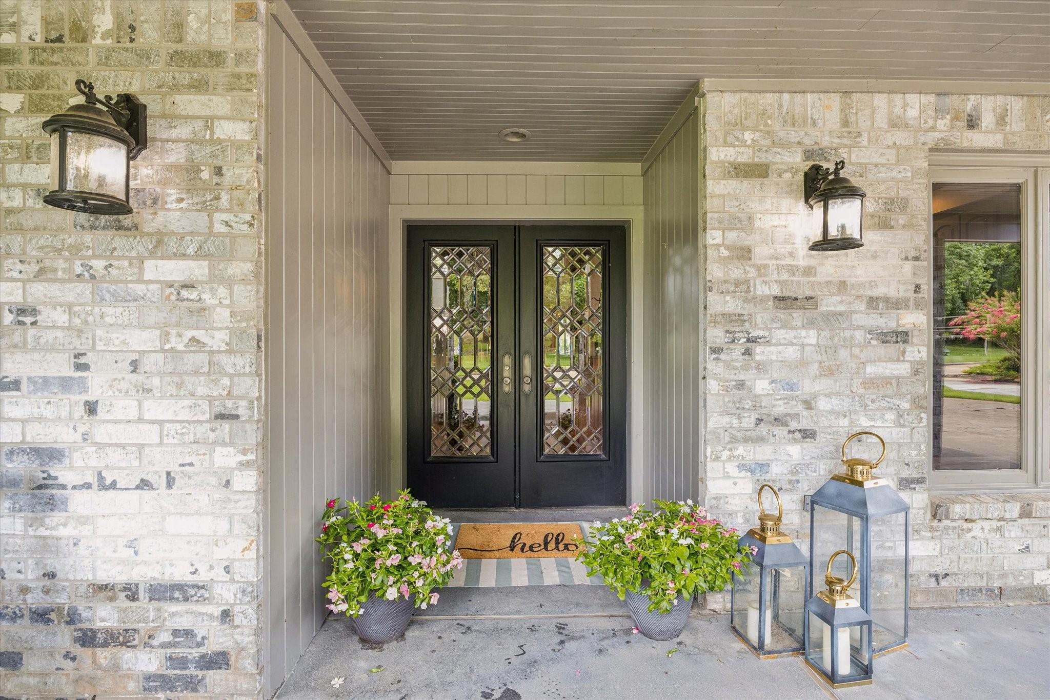 Image 3: Beautiful covered front porch featuring elegant g
