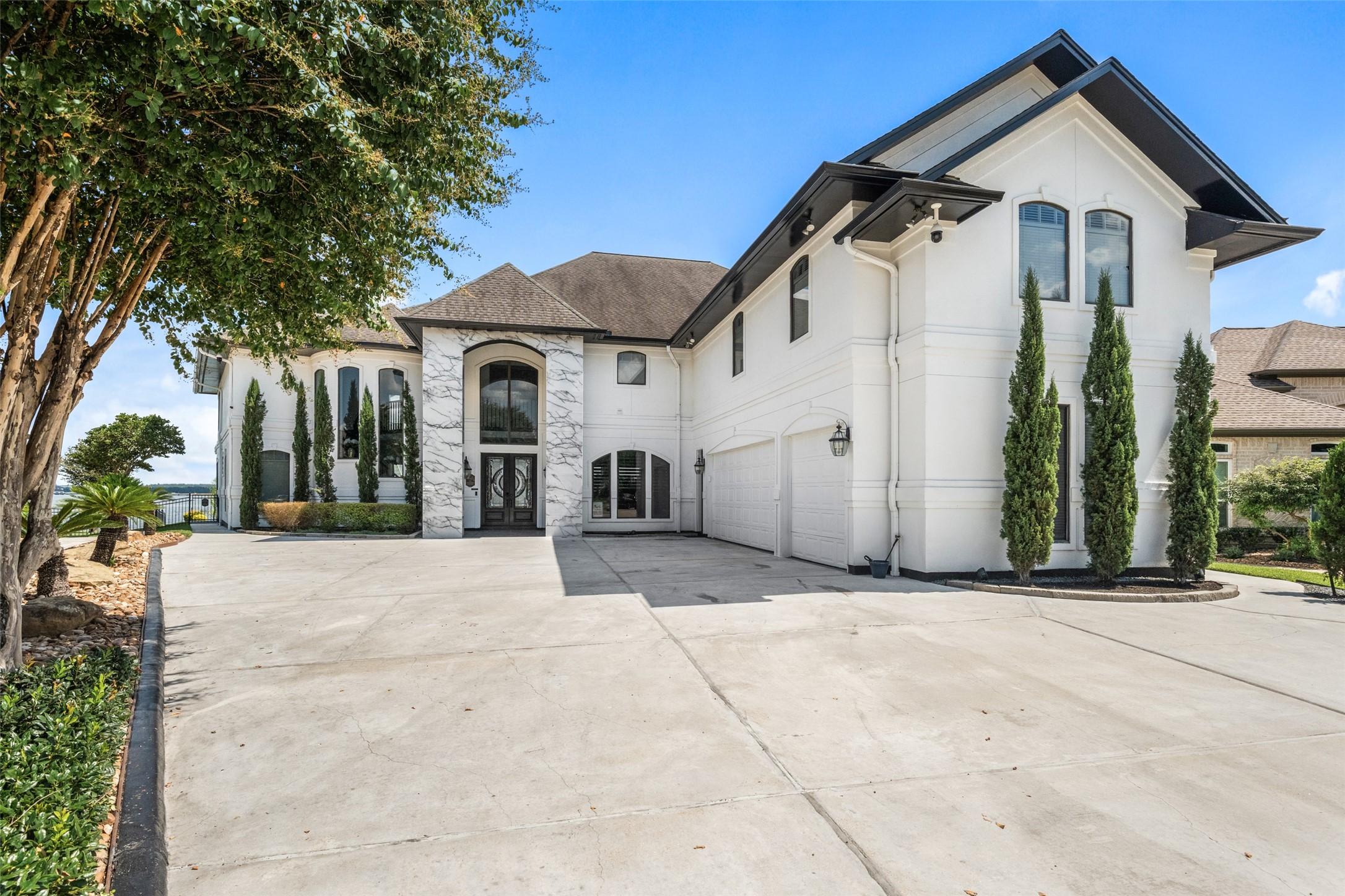 Image 3: Front of the home with stucco exterior and marble