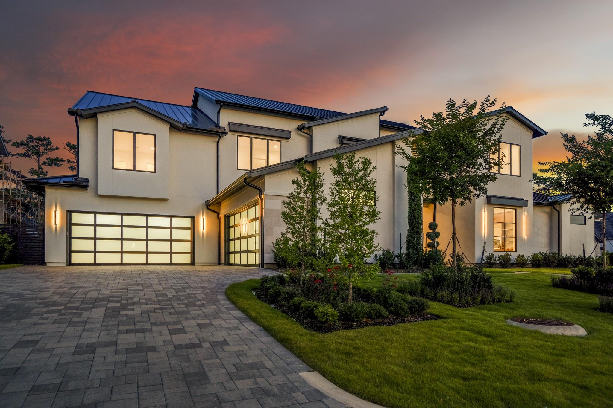 Image 4: Oversized four car garage and a paver driveway to