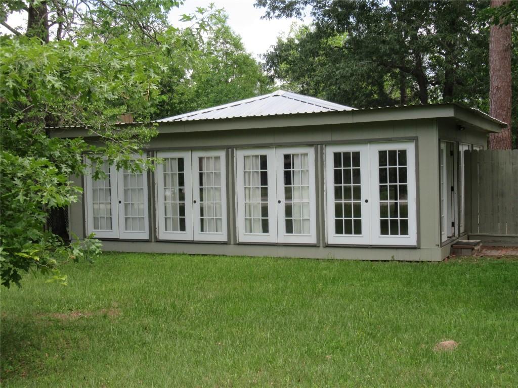 Image 1: French doors adorn the front entry to this country