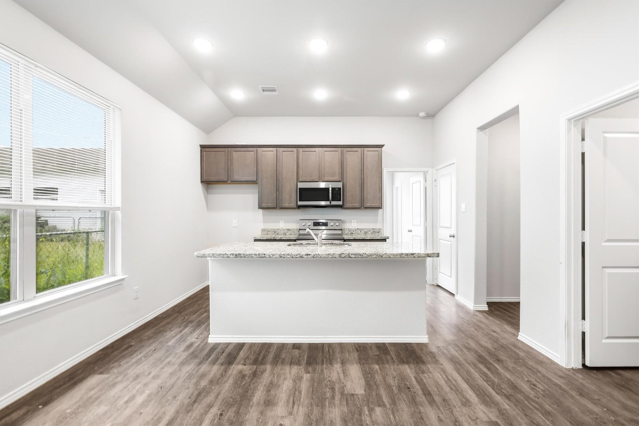 Image 4: As you come inside, the open layout immediately dr