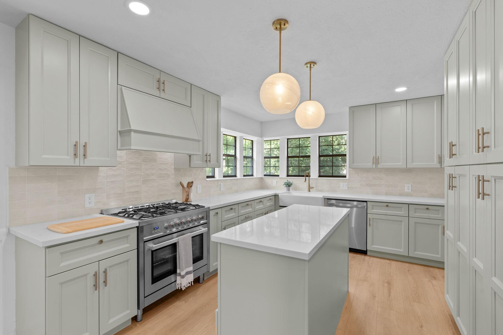 Image 3: Bright and beautiful kitchen featuring a wall of b