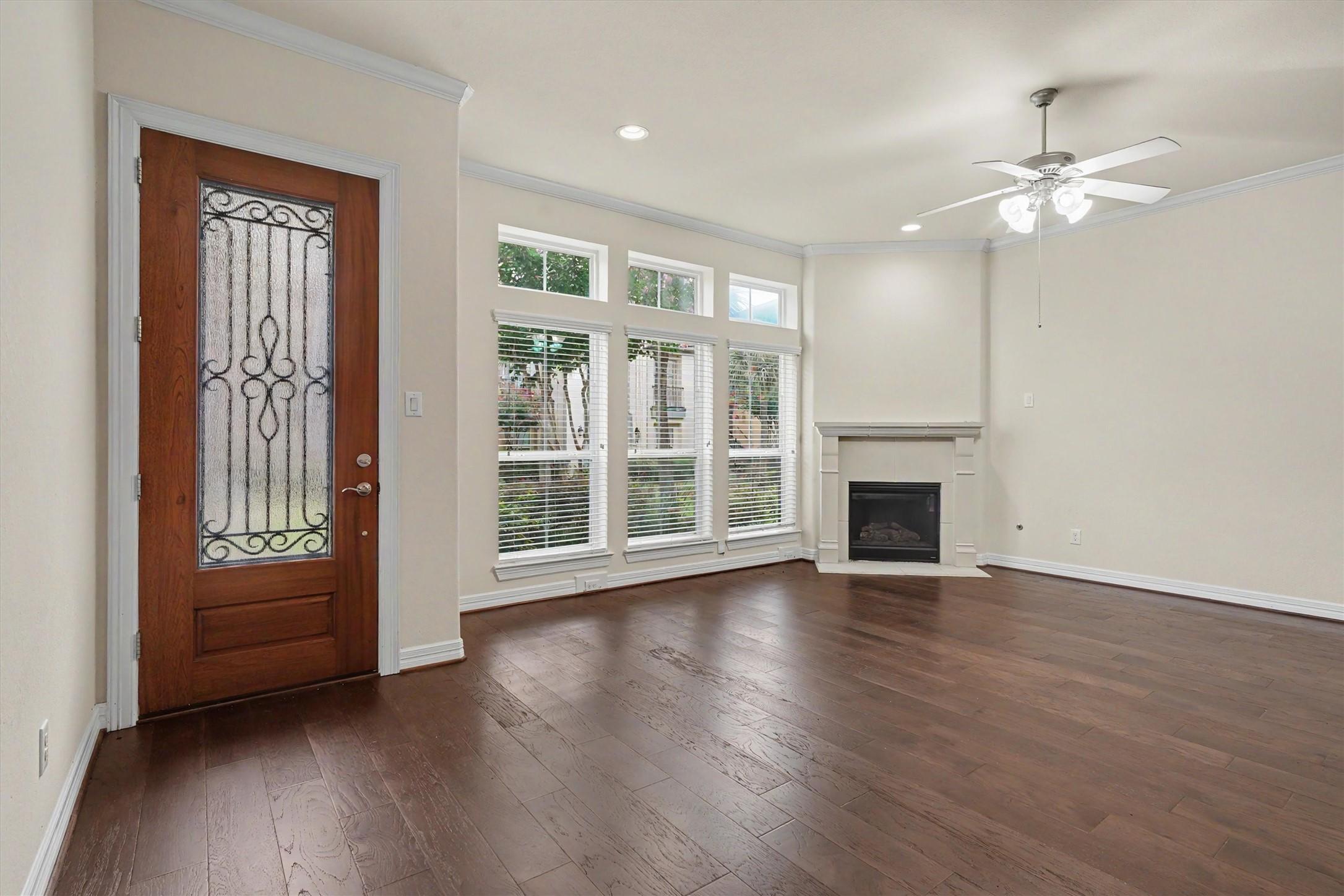 Image 3: Bright and inviting living room featuring a cozy g