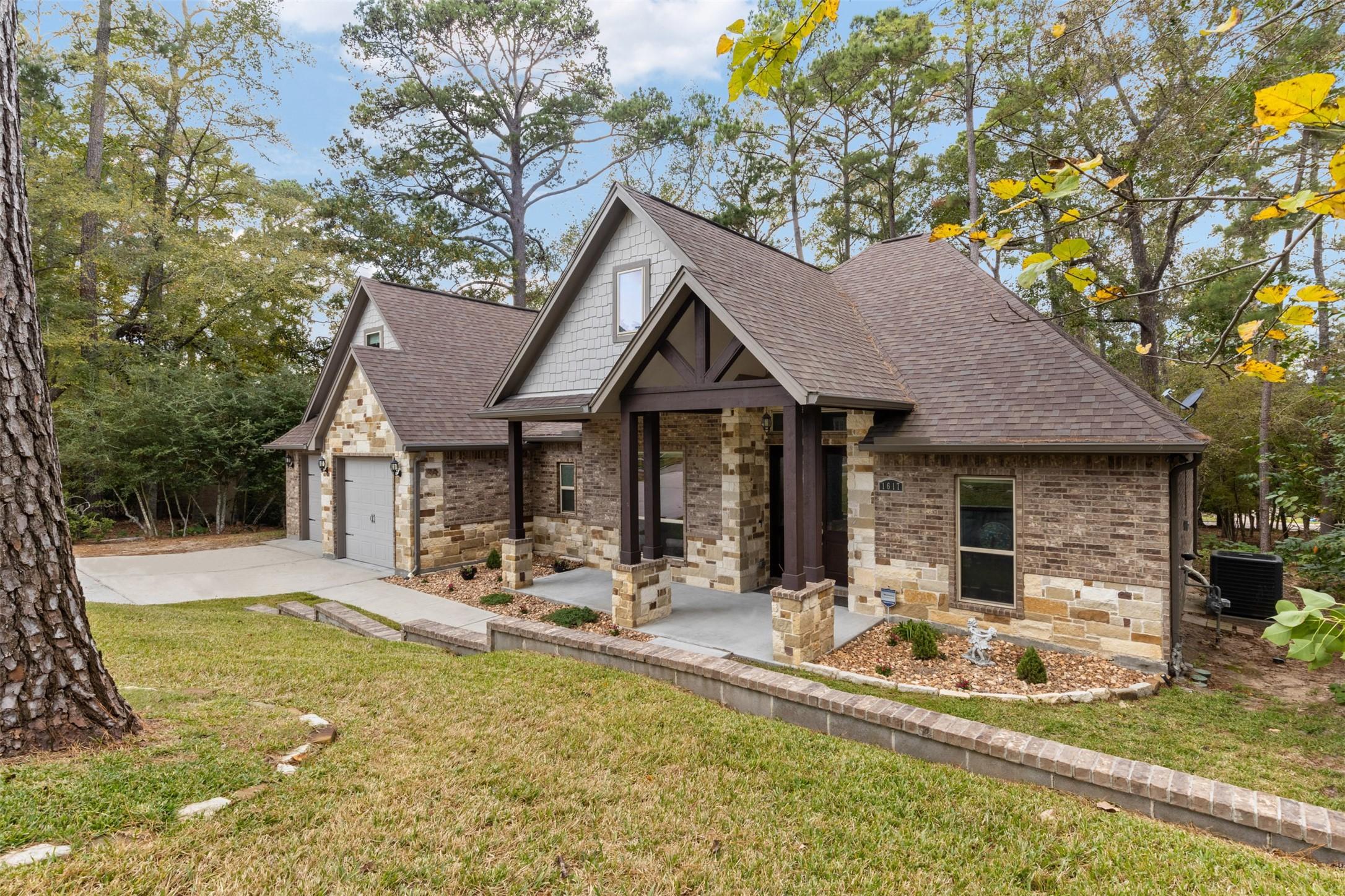 Image 2: One and half story home with a rustic stone exteri