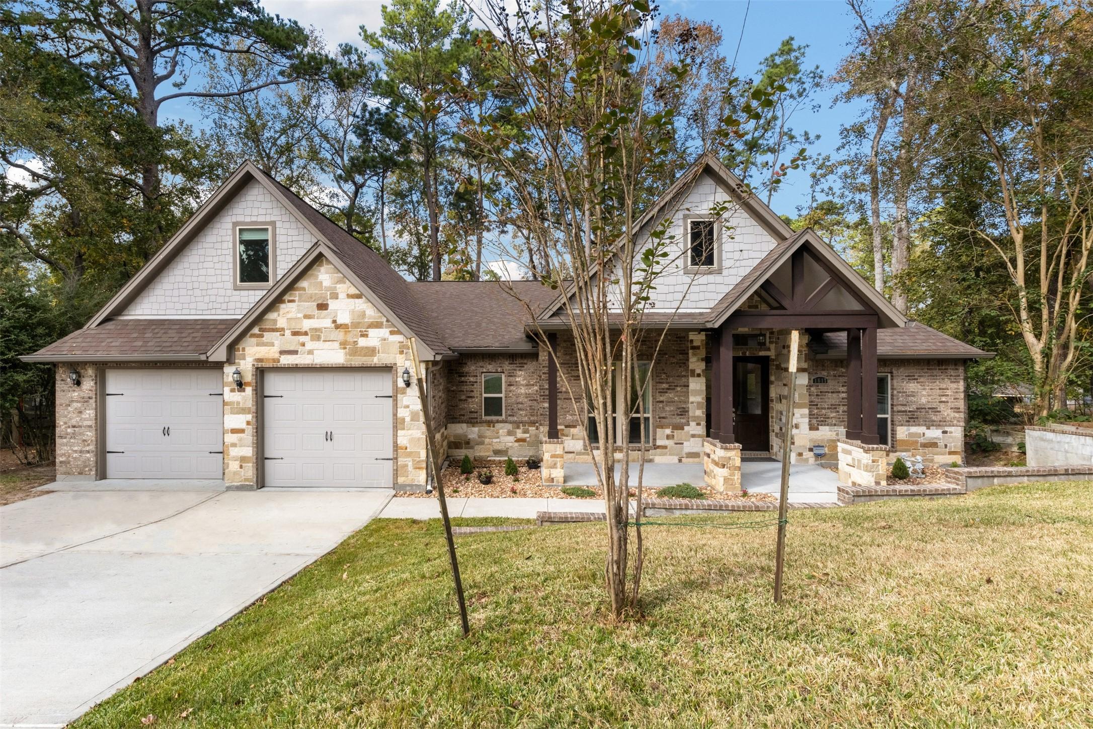Image 3: A two-car garage and welcoming front porch cedar a