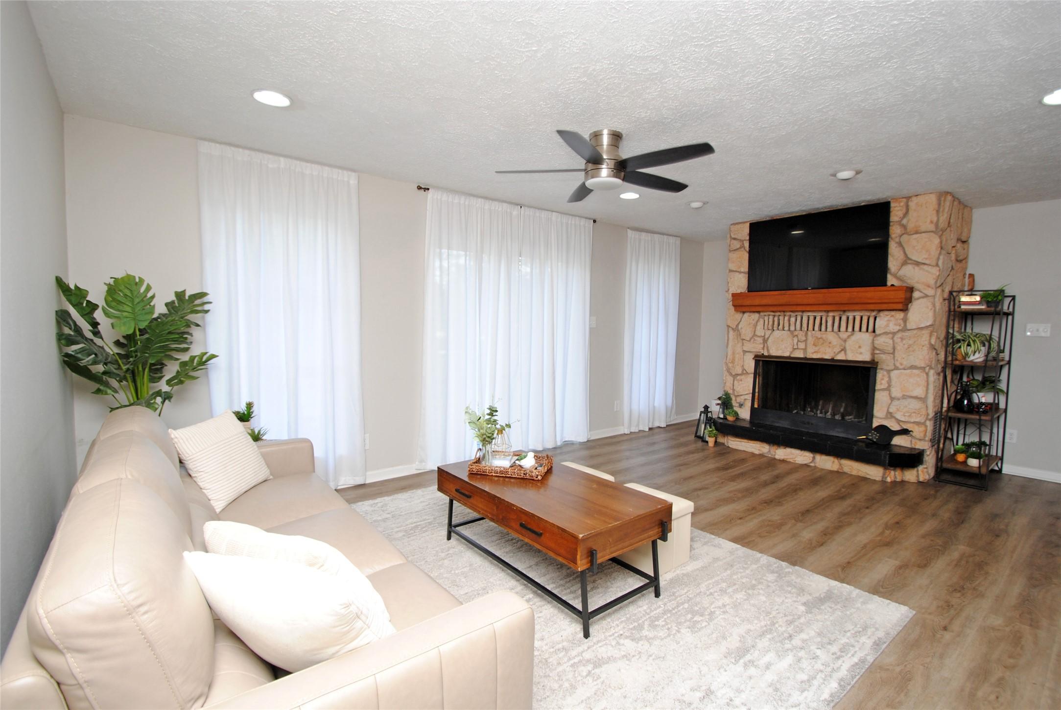 Image 3: Open living room with unique fireplace