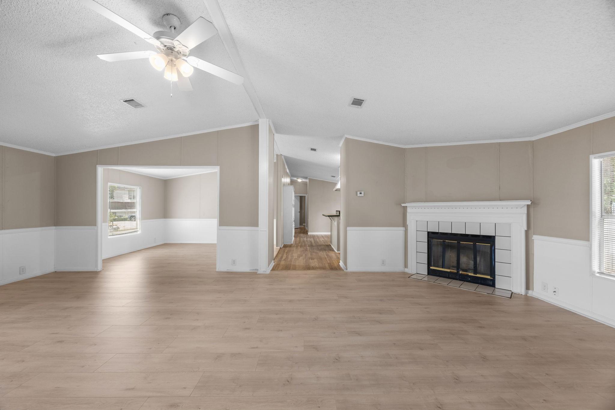 Image 4: Living room with corner wood burning fireplace and