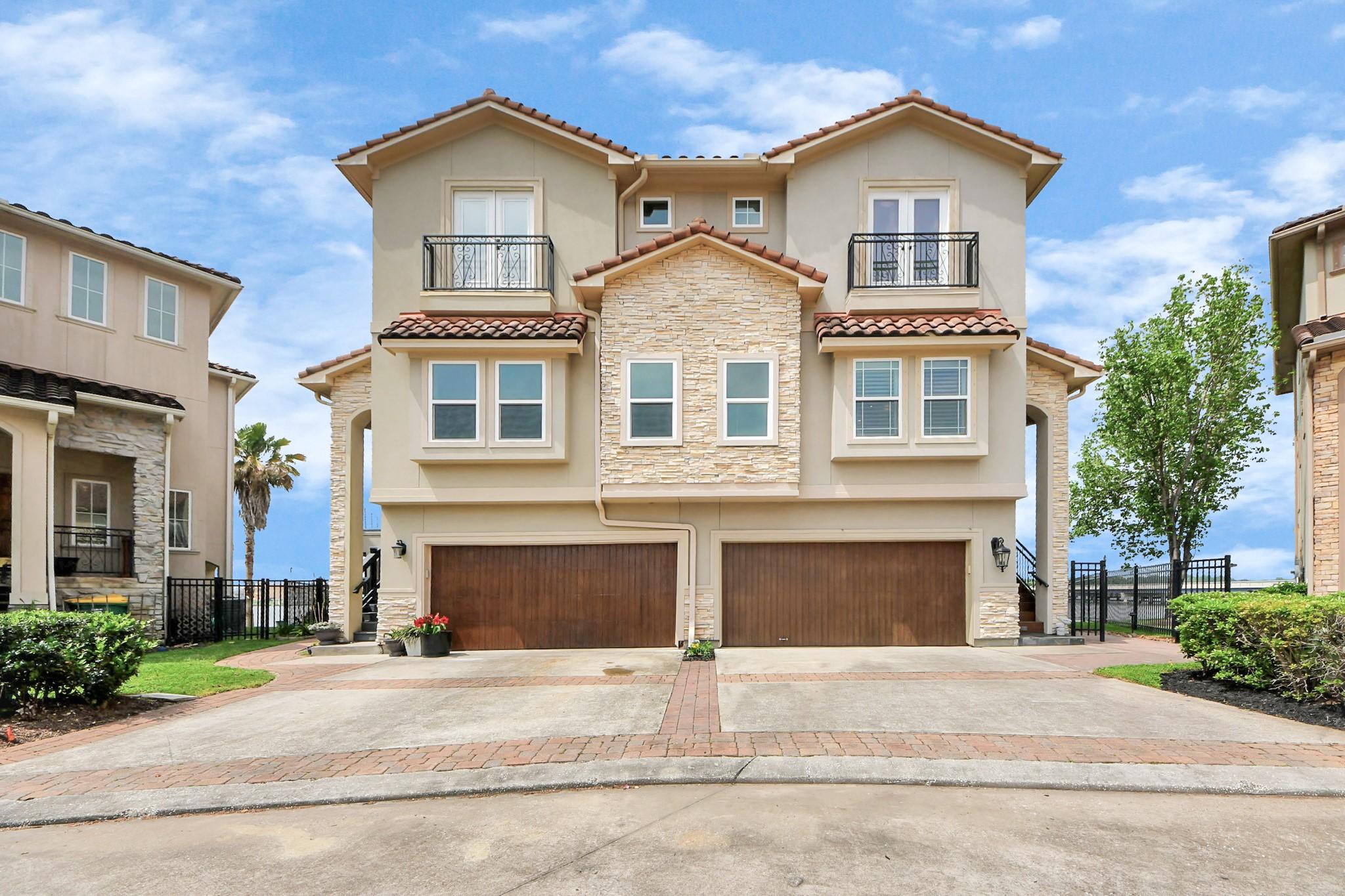 Image 2: This is a modern, three-story townhome with a stuc