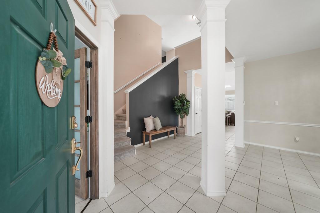 Image 2: Welcoming foyer with soaring ceilings creates an i