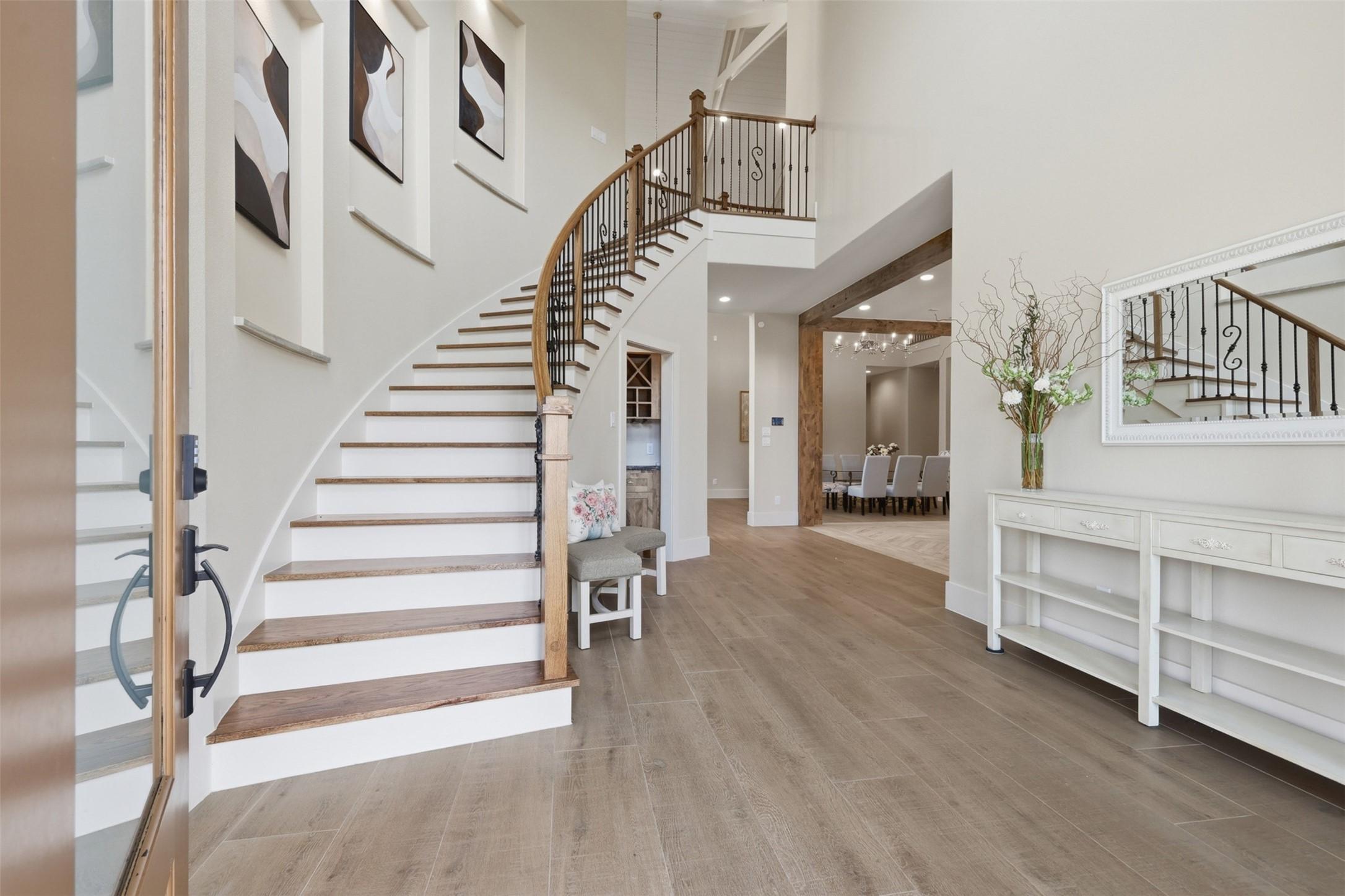 Image 2: Step into a foyer designed for impact. This shot h