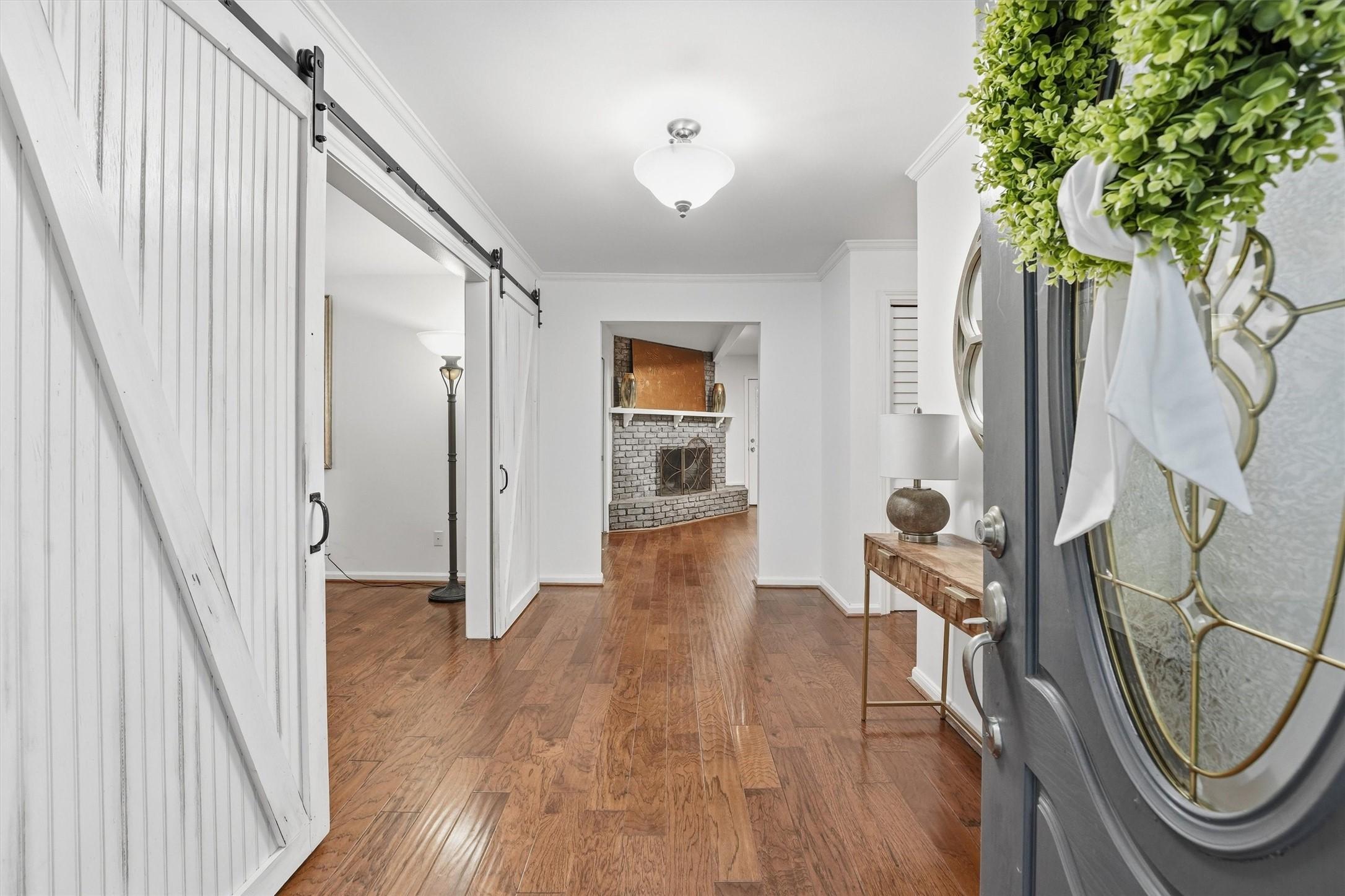 Image 3: Warm hardwood floors and a classic brick fireplace