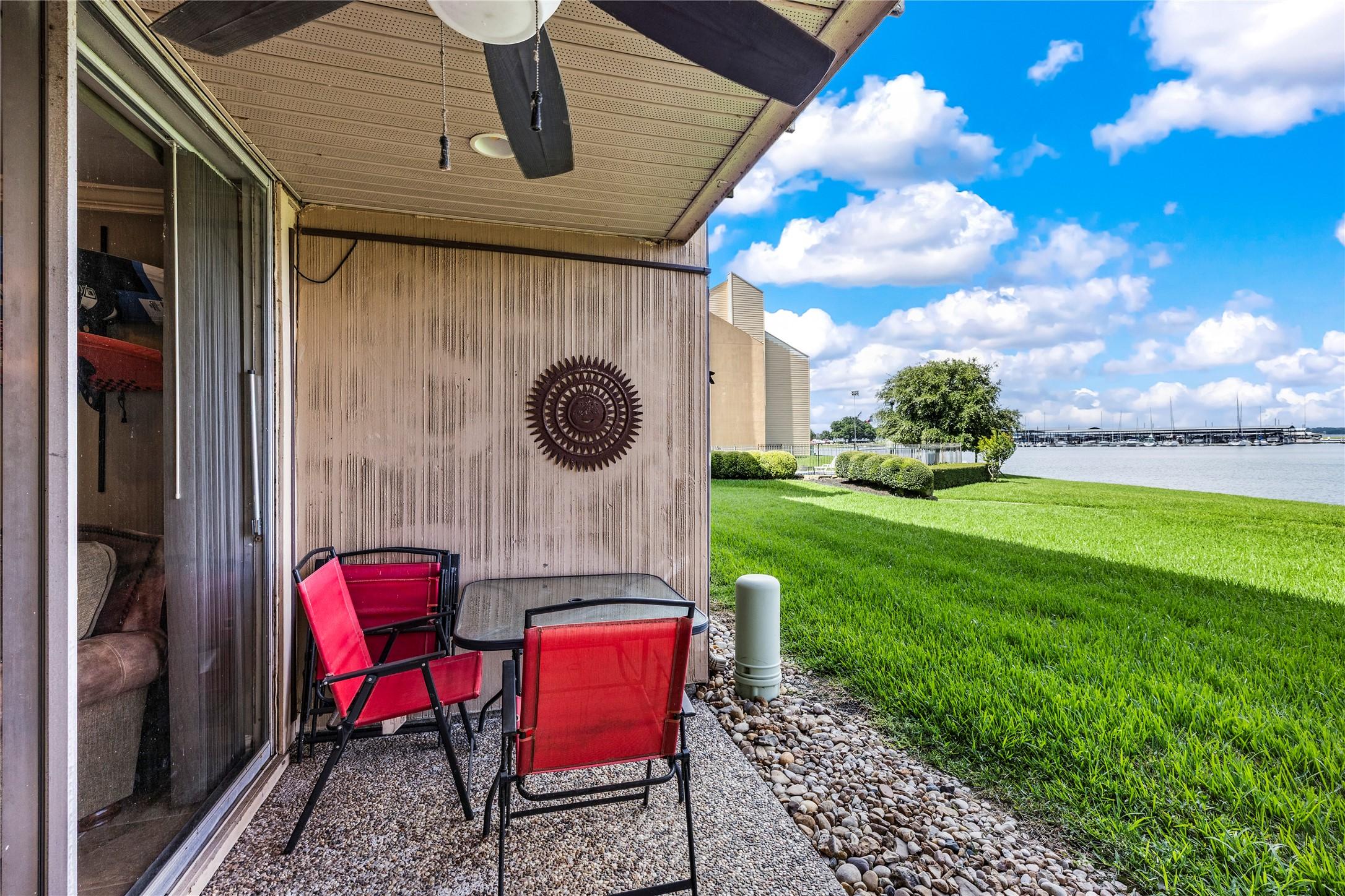 Image 2: Covered patio with steps to Lake Conroe.