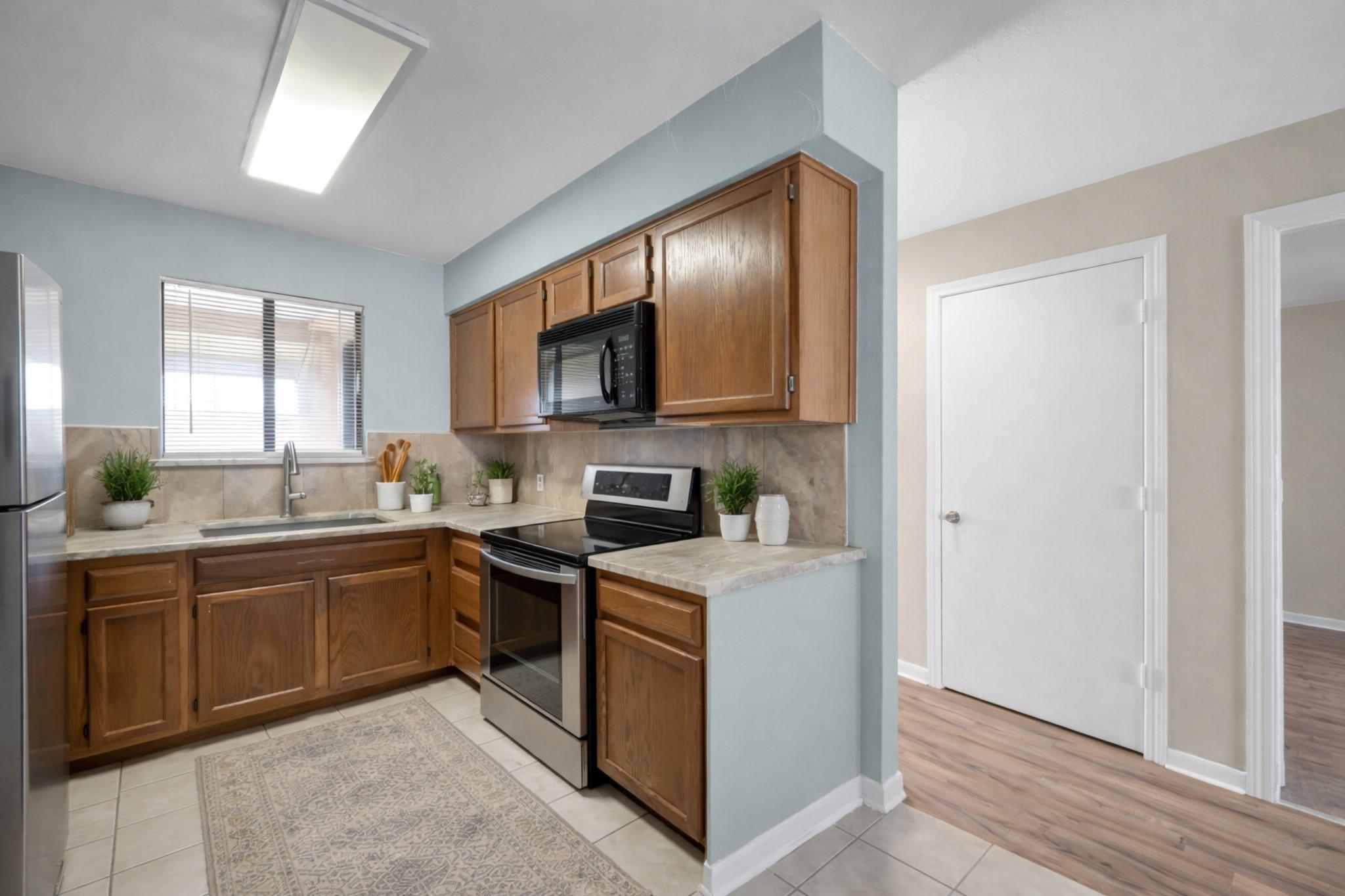 Image 3: Open concept kitchen space with beautiful quart co