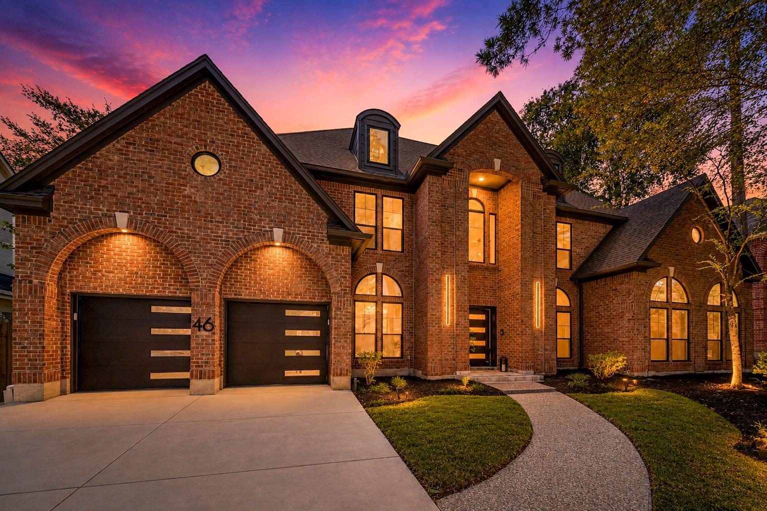 Image 1: Stunning brick home with elegant arched windows, m