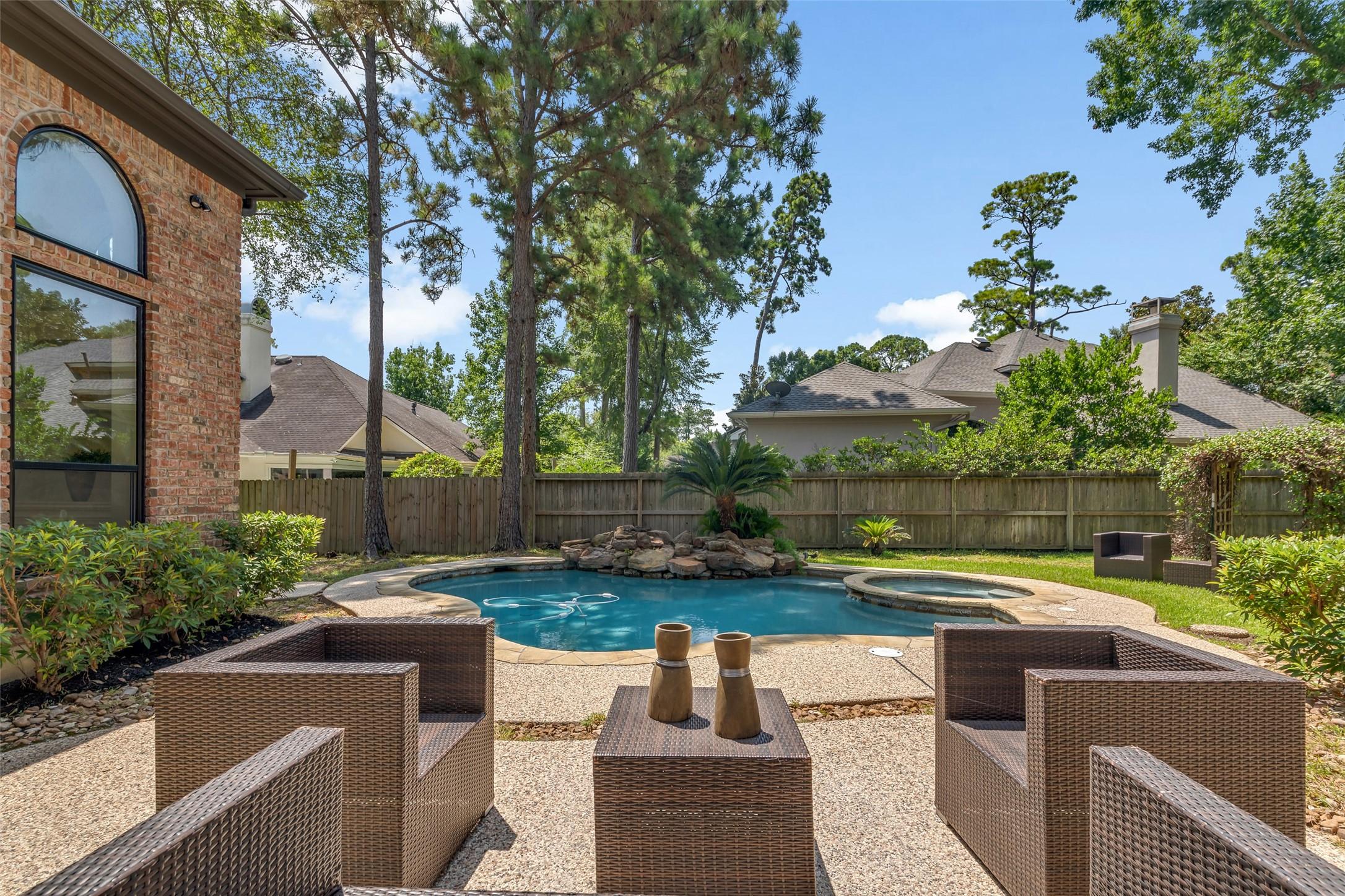 Image 2: Tranquil backyard oasis featuring a sparkling pool