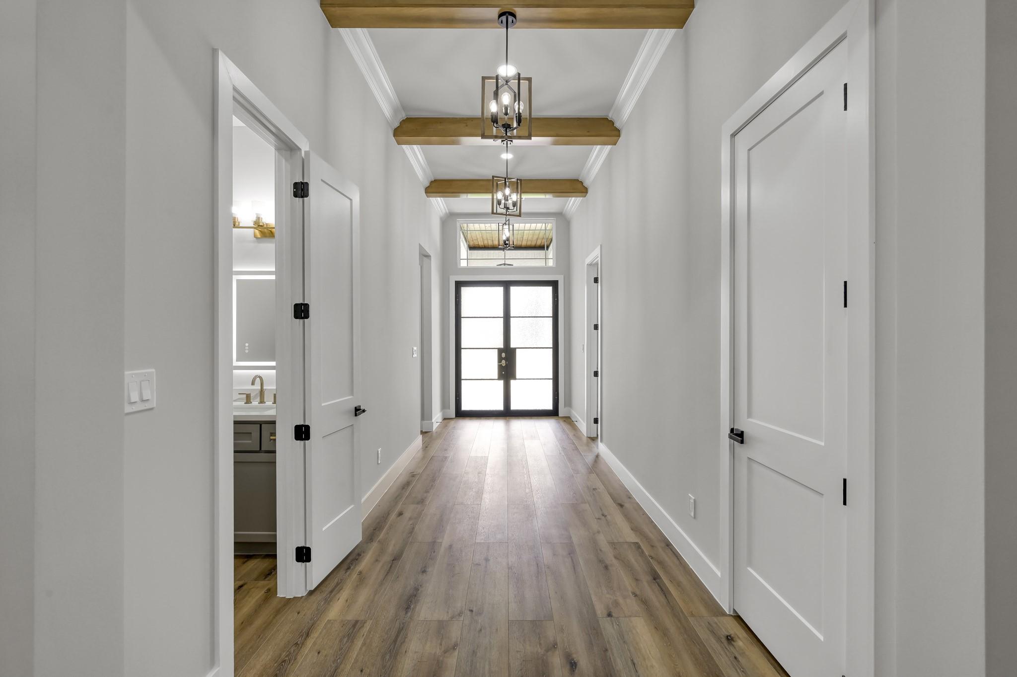 Image 4: The iron and glass double front doors allow ample