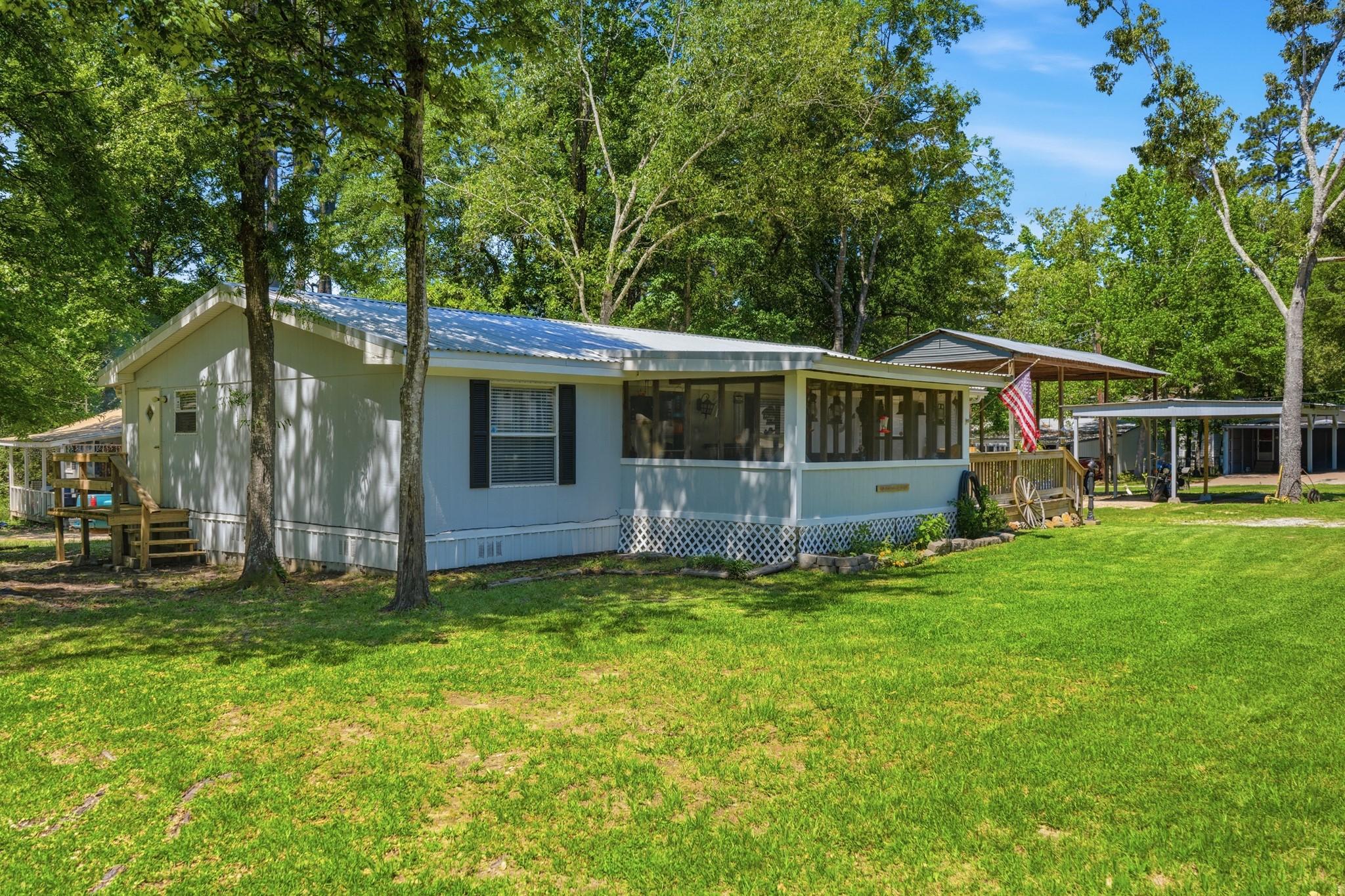 Image 2: Large screened in front porch in the front.