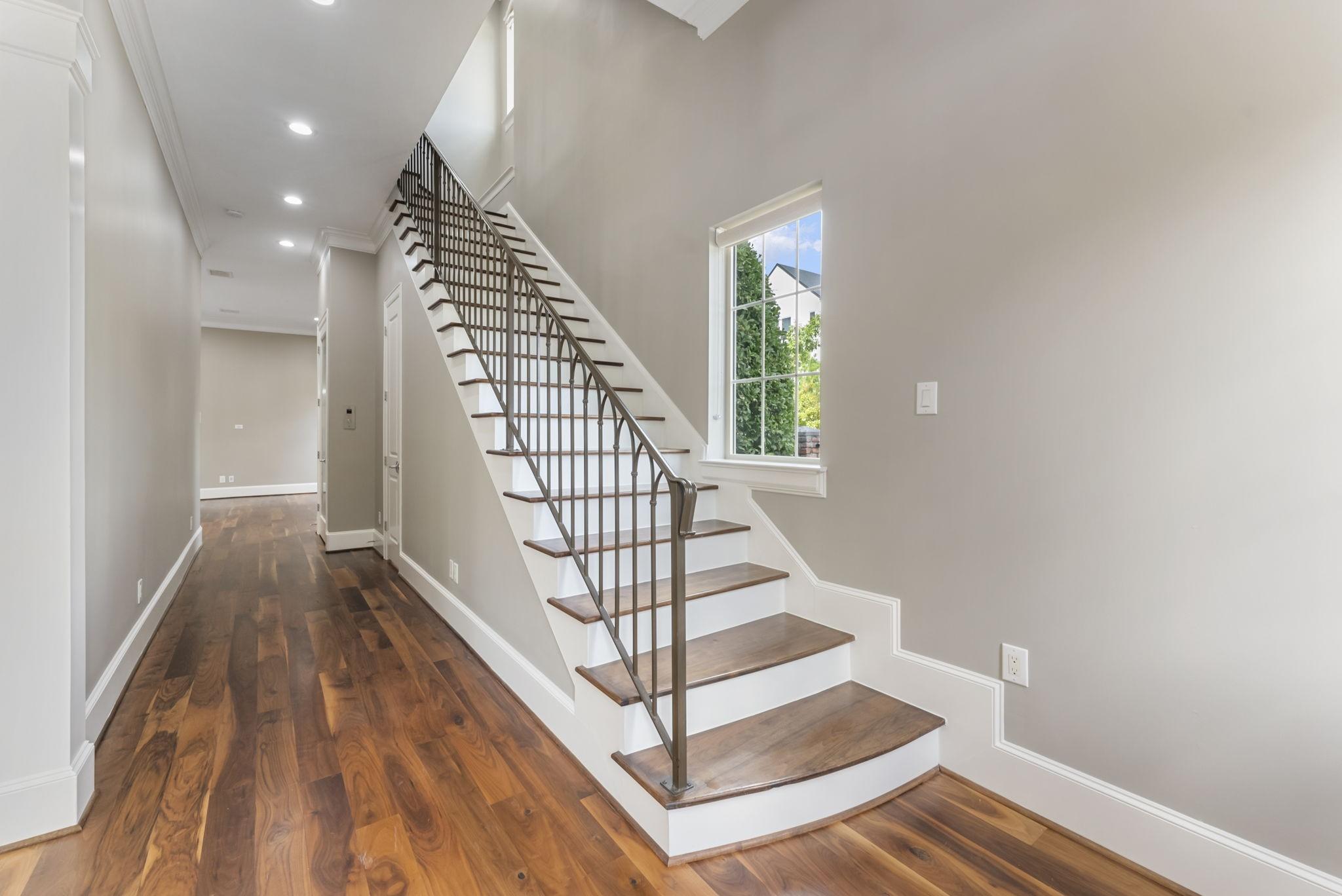 Image 2: Step inside to rich wood flooring, crown molding,