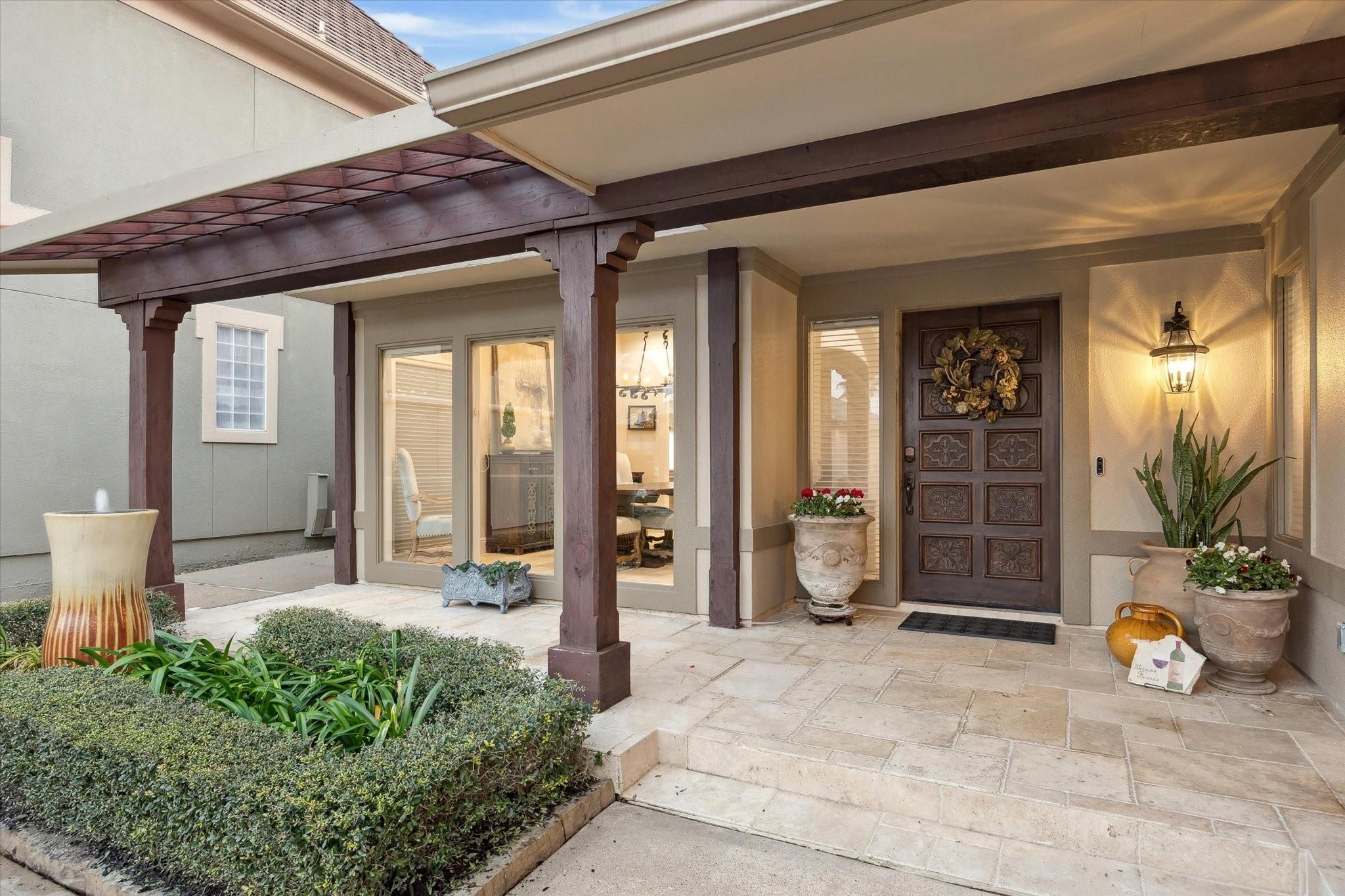 Image 4: INVITING FRONT PORCH WITH TRAVERTINE TILE AND WATE