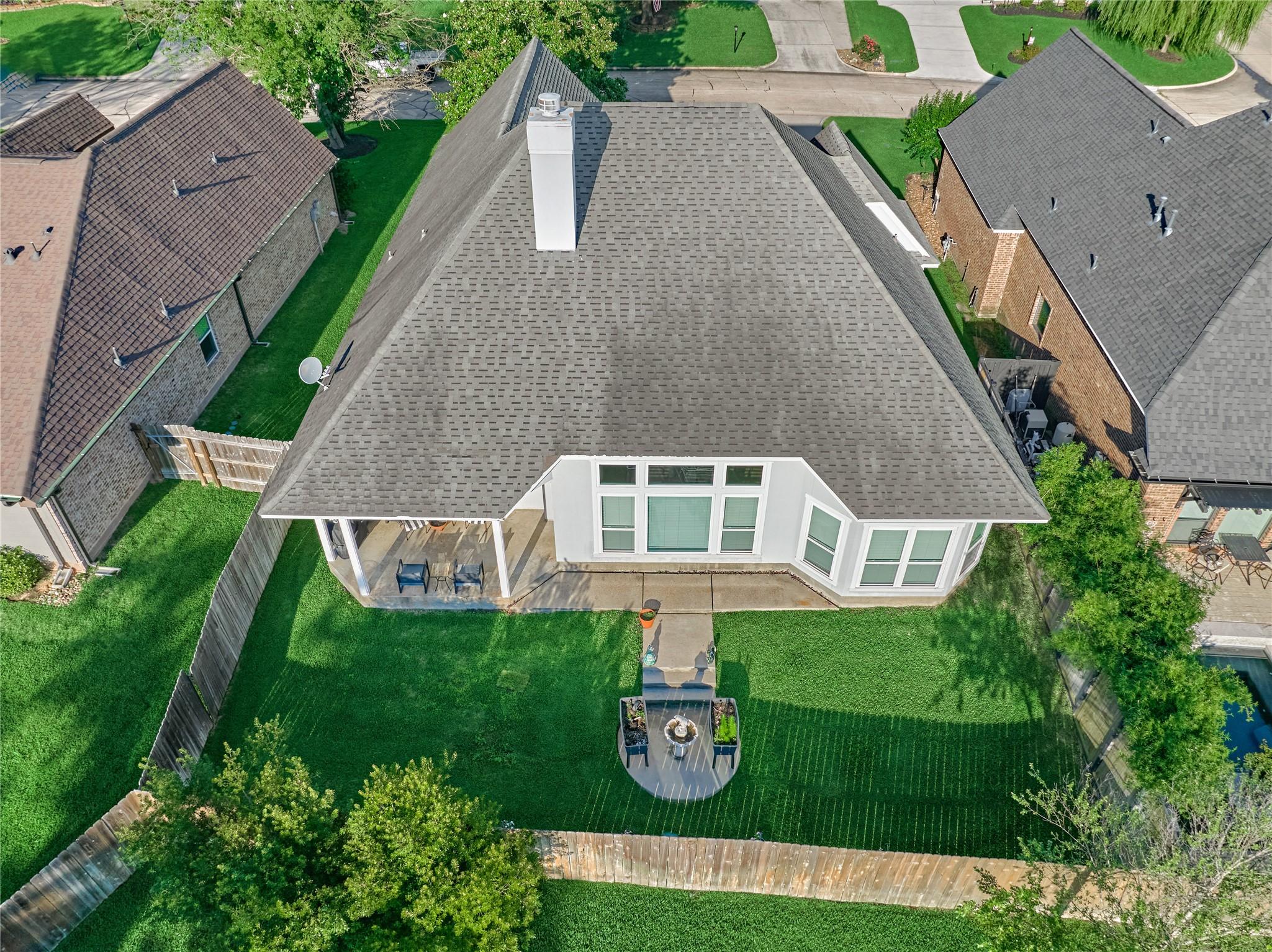 Image 2: Backyard retreat features a covered patio, perfect
