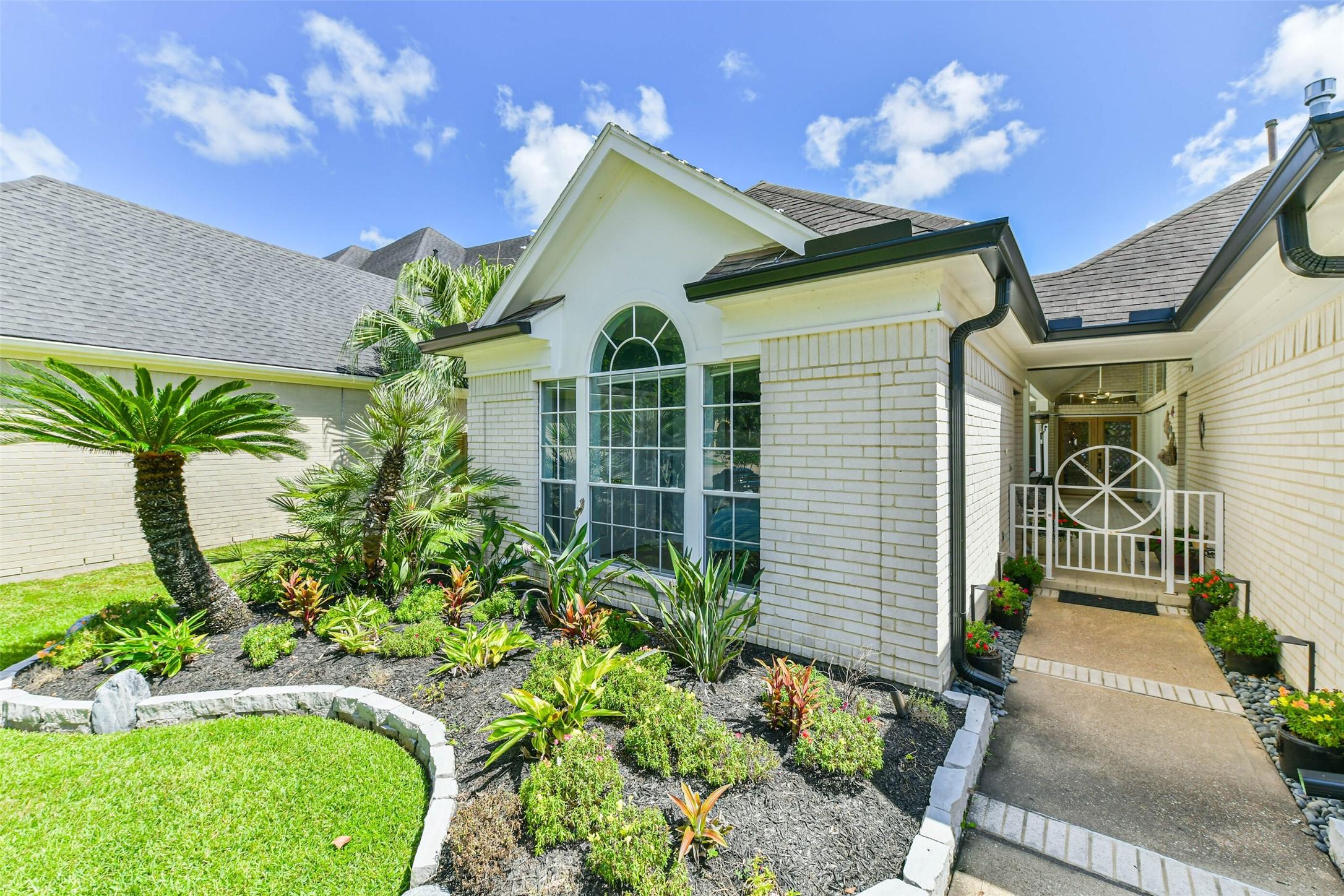 Image 2: Lush, tropical landscaping gives the curb appeal 1