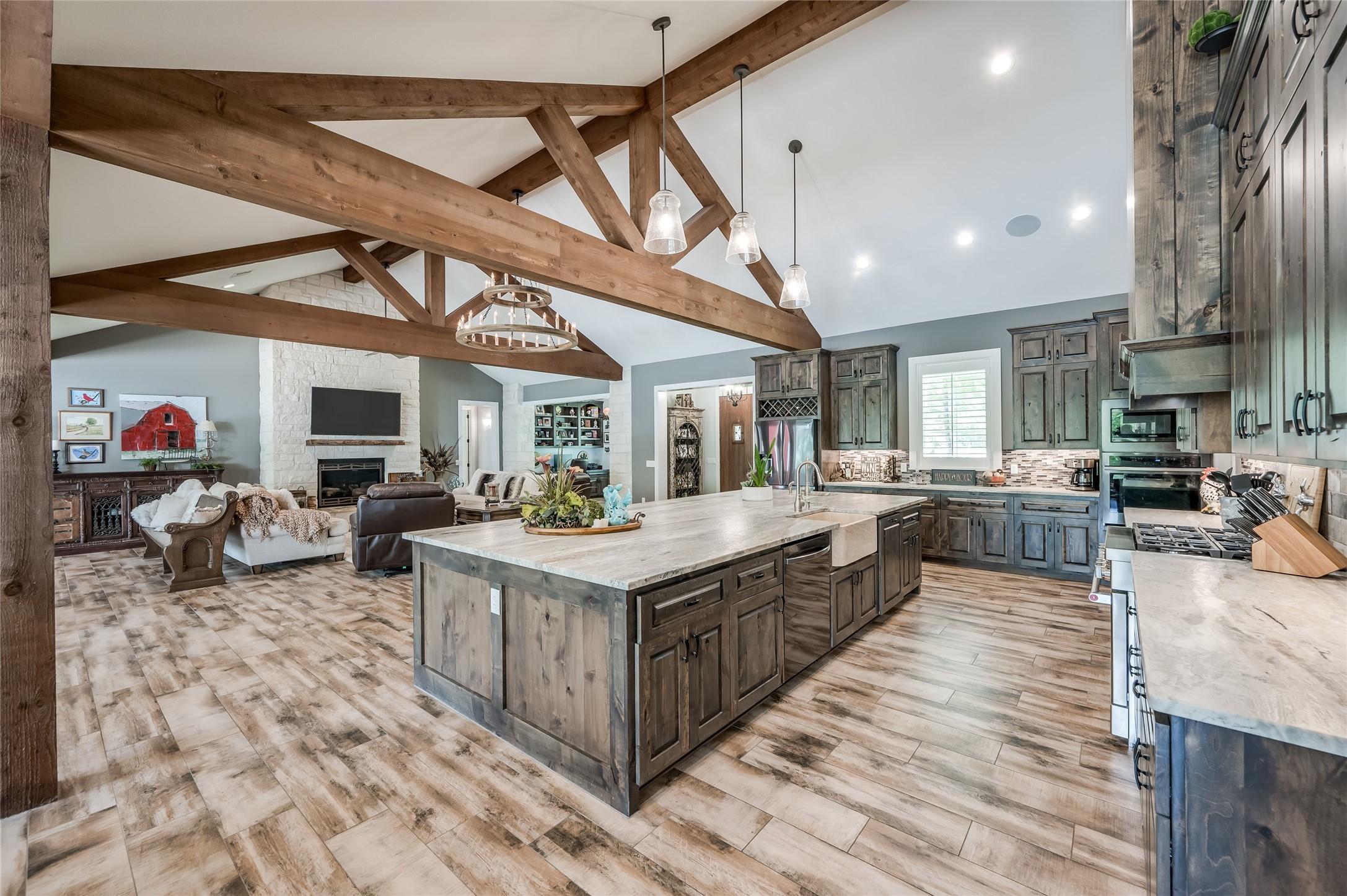 Image 4: Large wood beams that flank the vaulted ceilings i