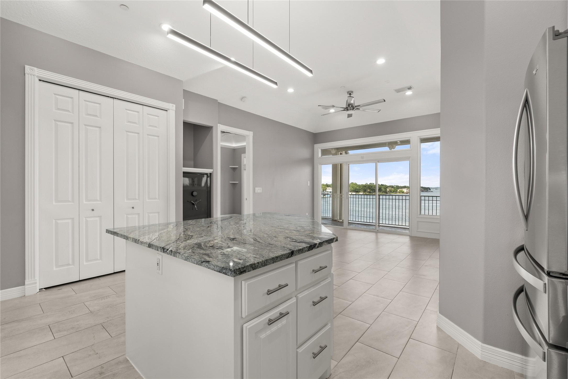 Image 4: This modern kitchen features a sleek island with g