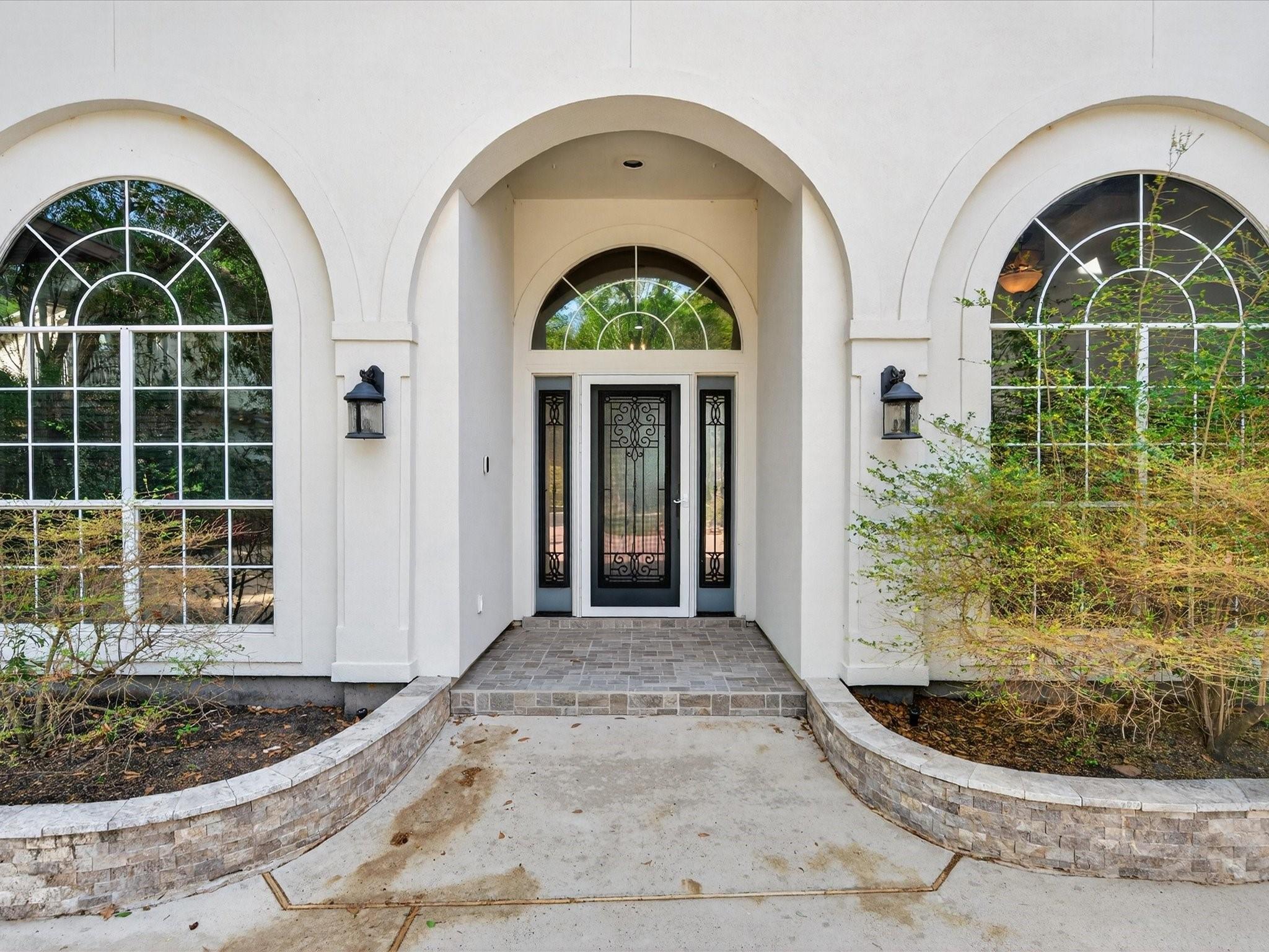 Image 4: Grand arched windows fill the space with natural l