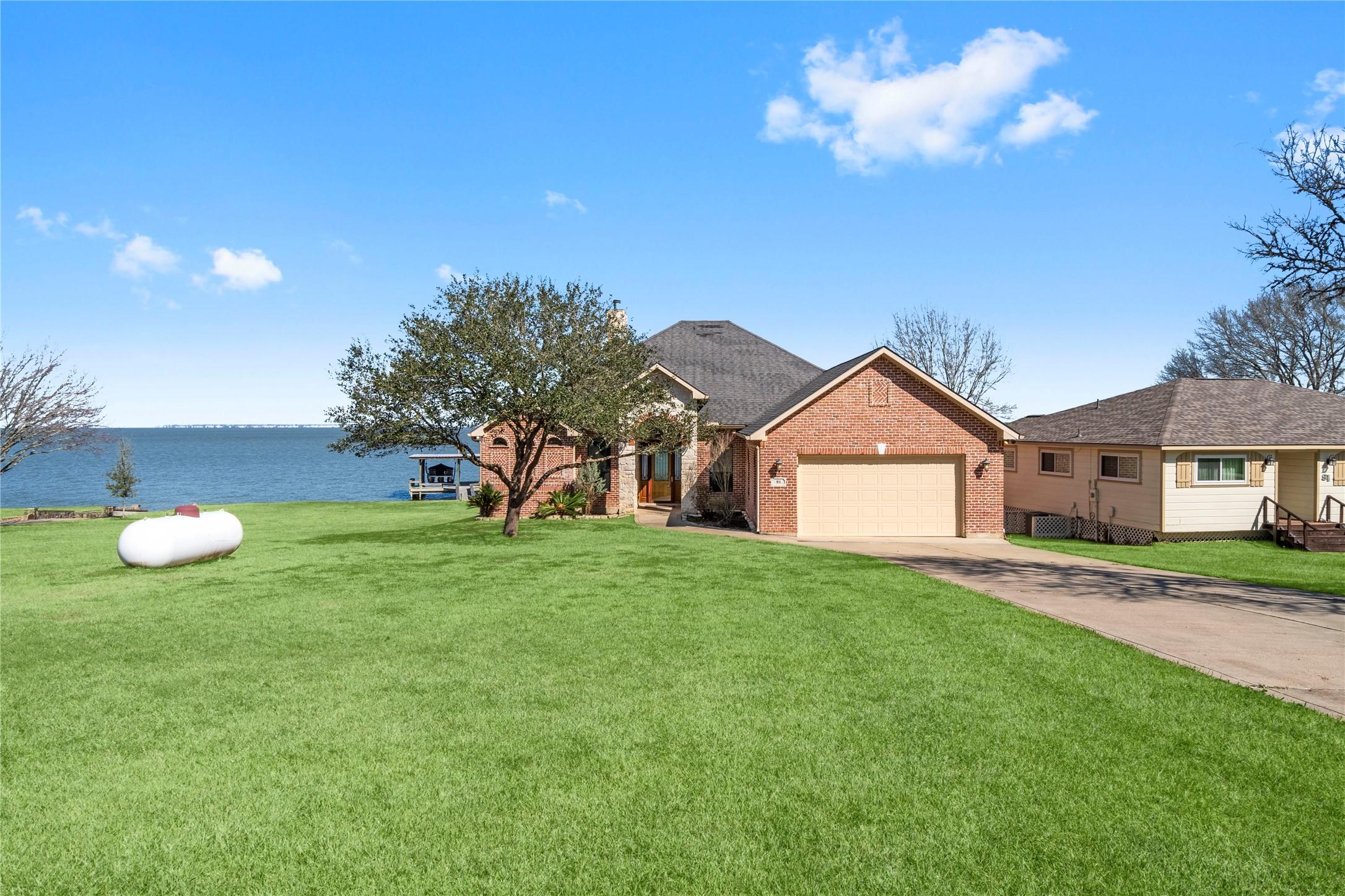 Image 2: This photo showcases a charming waterfront brick h
