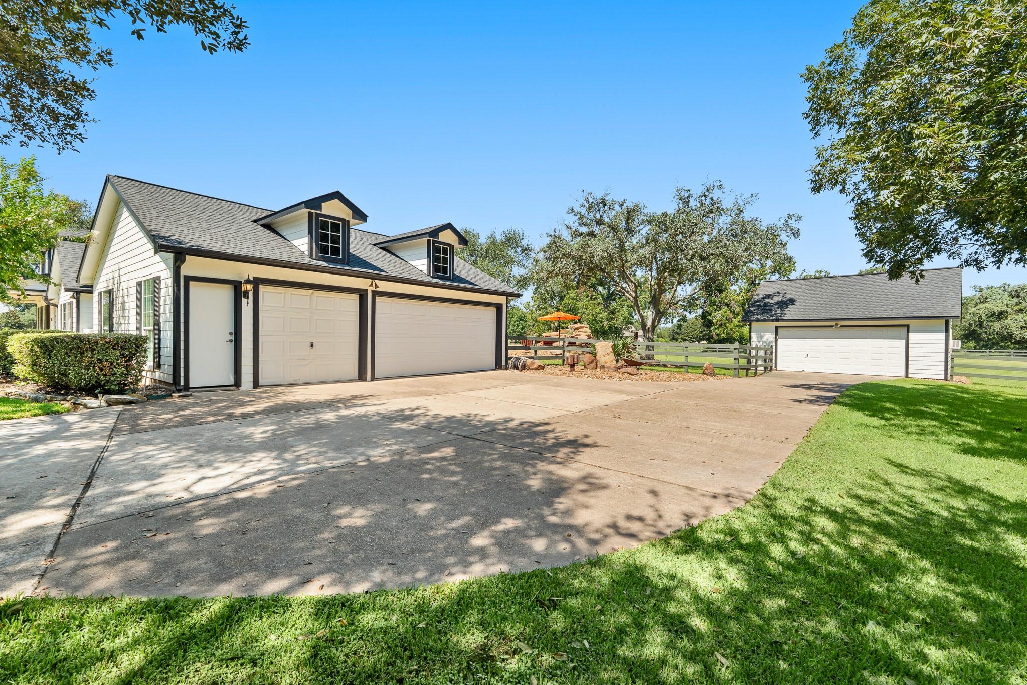 Image 3: A rare offering with two detached garages, this la