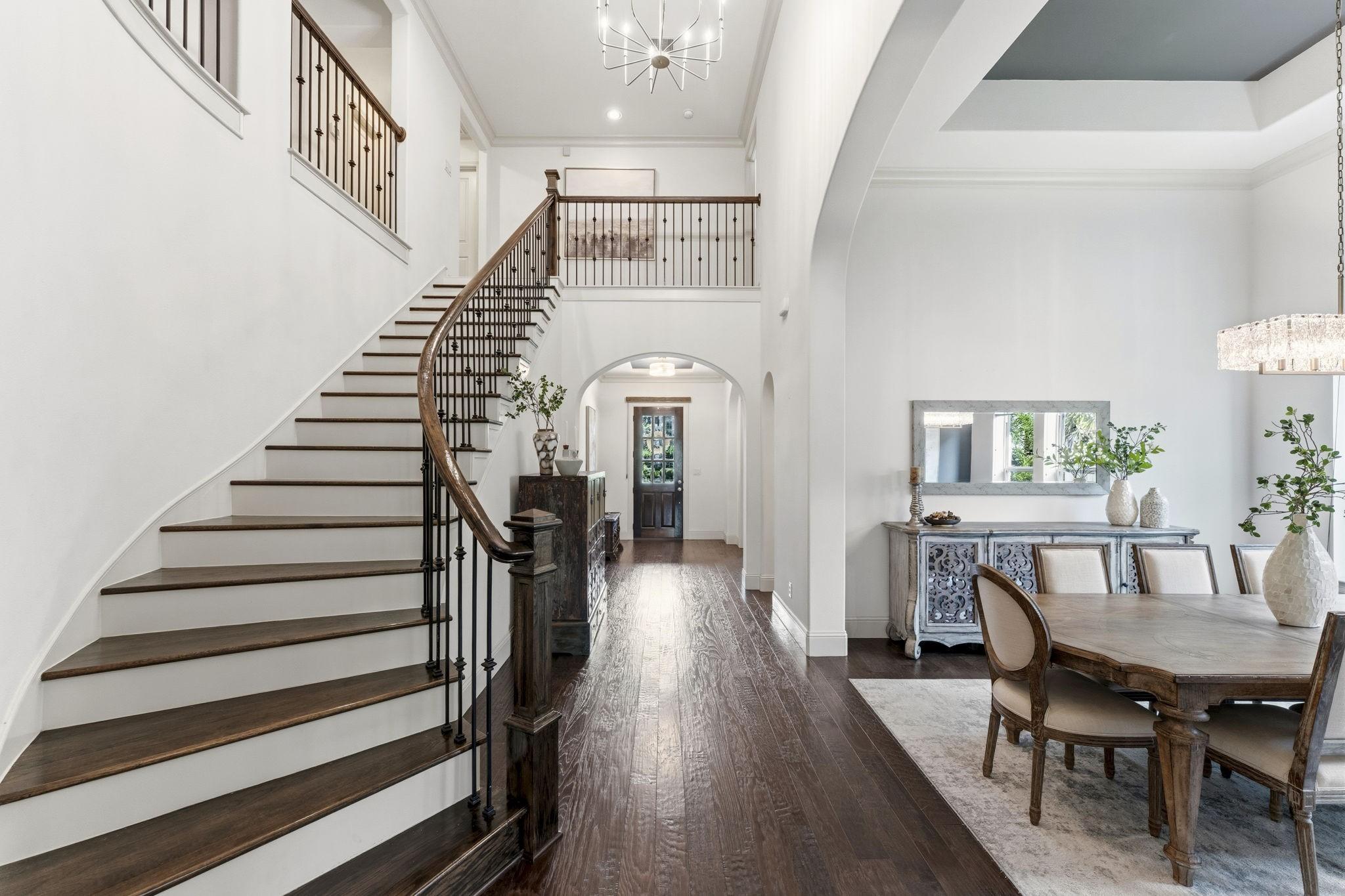 Image 3: Light and bright entryway with sweeping staircase