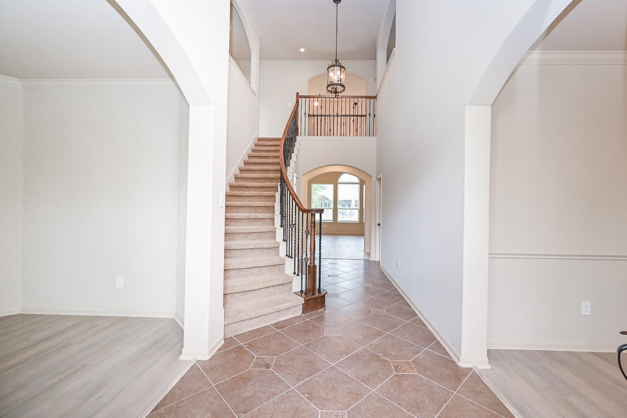 Image 3: Grand foyer with formal dining room off to the rig