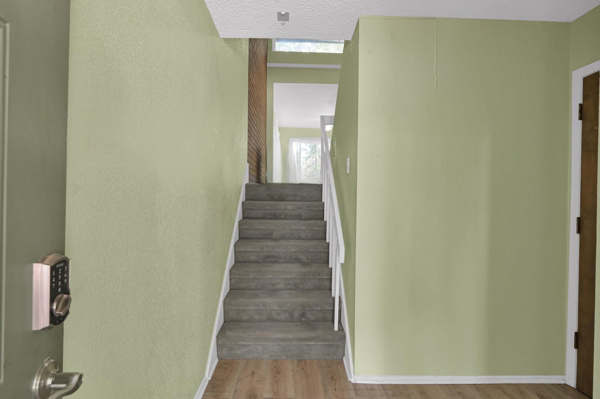 Image 3: A welcoming entryway with light green walls, featu